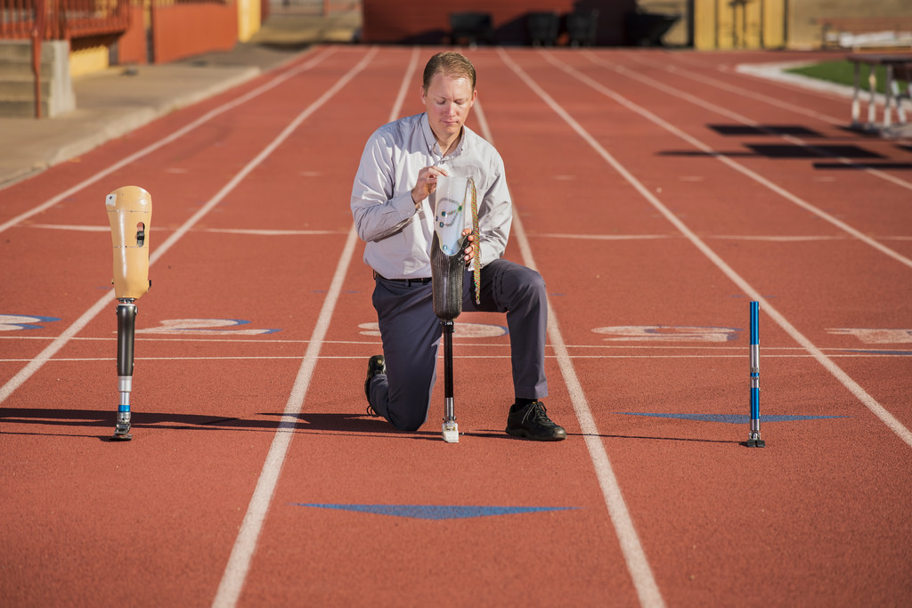 Sandia National Laboratories engineer Jason Wheeler demonstrates a liner aimed at helping prosthetic limbs fit better. It is outfitted with sensors that tell what’s going on in a limb and a system to automatically accommodate changes.