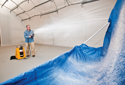 Researcher Mark Tucker demonstrates the application of Sandia-developed decontamination foam. The foam, used 10 years ago in the cleanup effort following the deadly 2001 anthrax attacks, is now being used to decontaminate environmentally devastating meth labs.