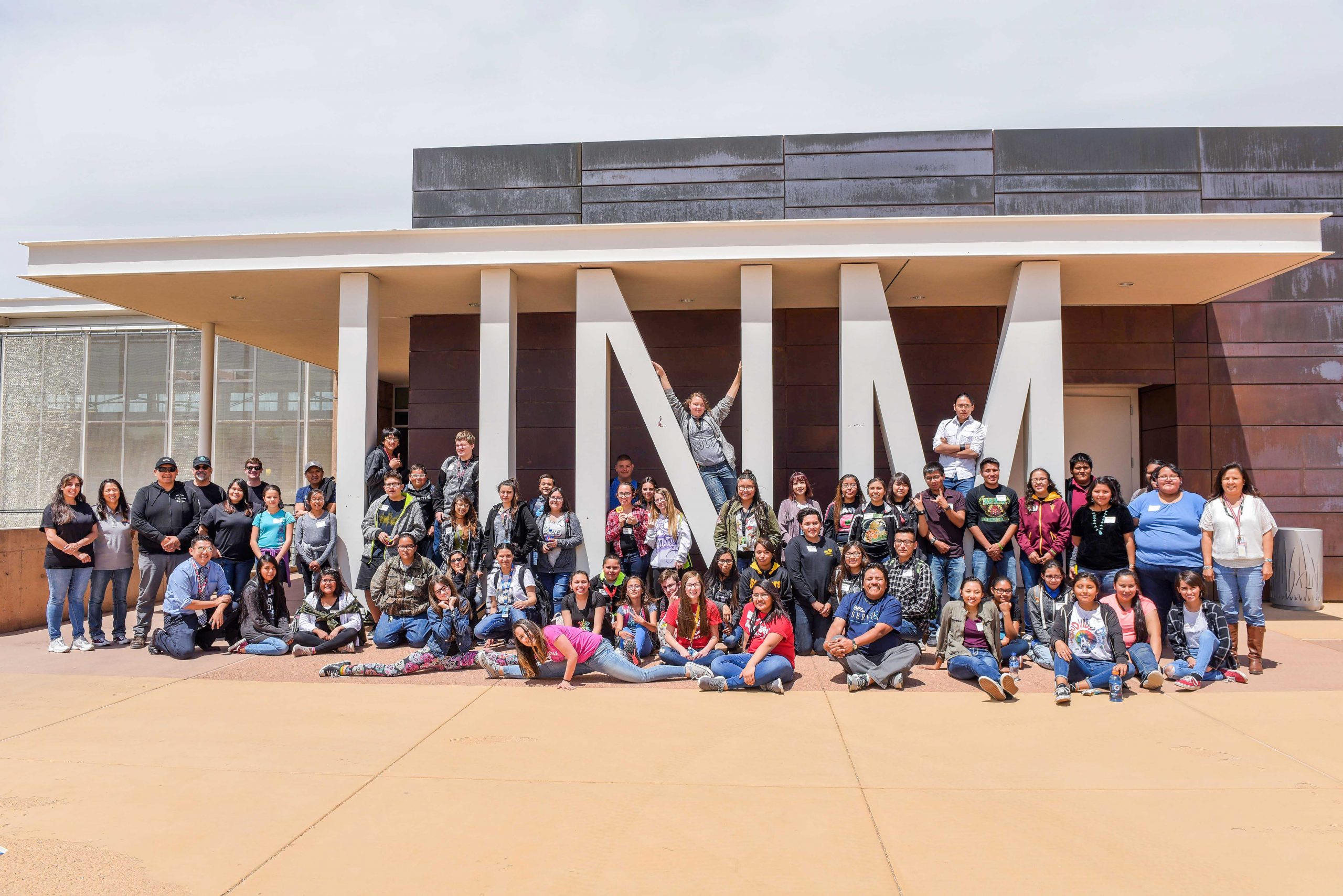 Sandia National Laboratories volunteers pose with students from Los Alamitos Middle School and Thoreau High School outside of the University of New Mexico campus in Gallup, New Mexico.