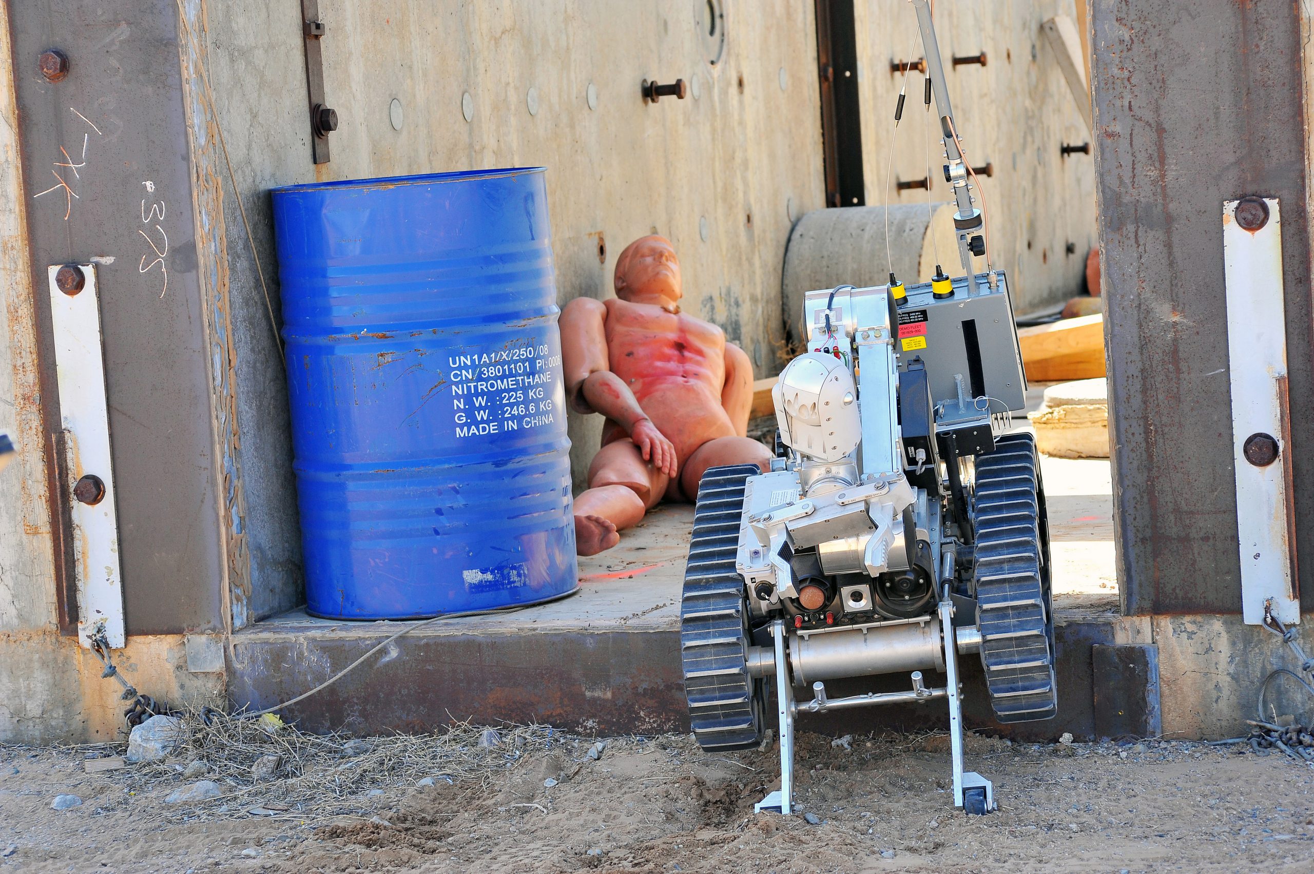 A robot performs a rescue operation on a dummy victim in a training exercise at a previous Robot Rodeo.