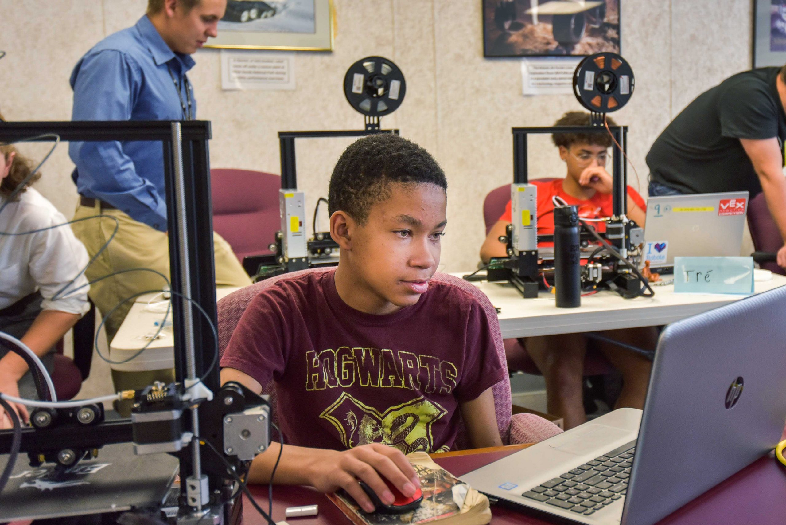 Teens work with 3D printers during a robotics camp competition last May at Sandia National Laboratories. The camp was held in collaboration with the nonprofit R4 Creating. About 20 teens associated with the STEM organization have made 3,000 face shields using 3D printers to help protect users during COVID-19 pandemic.