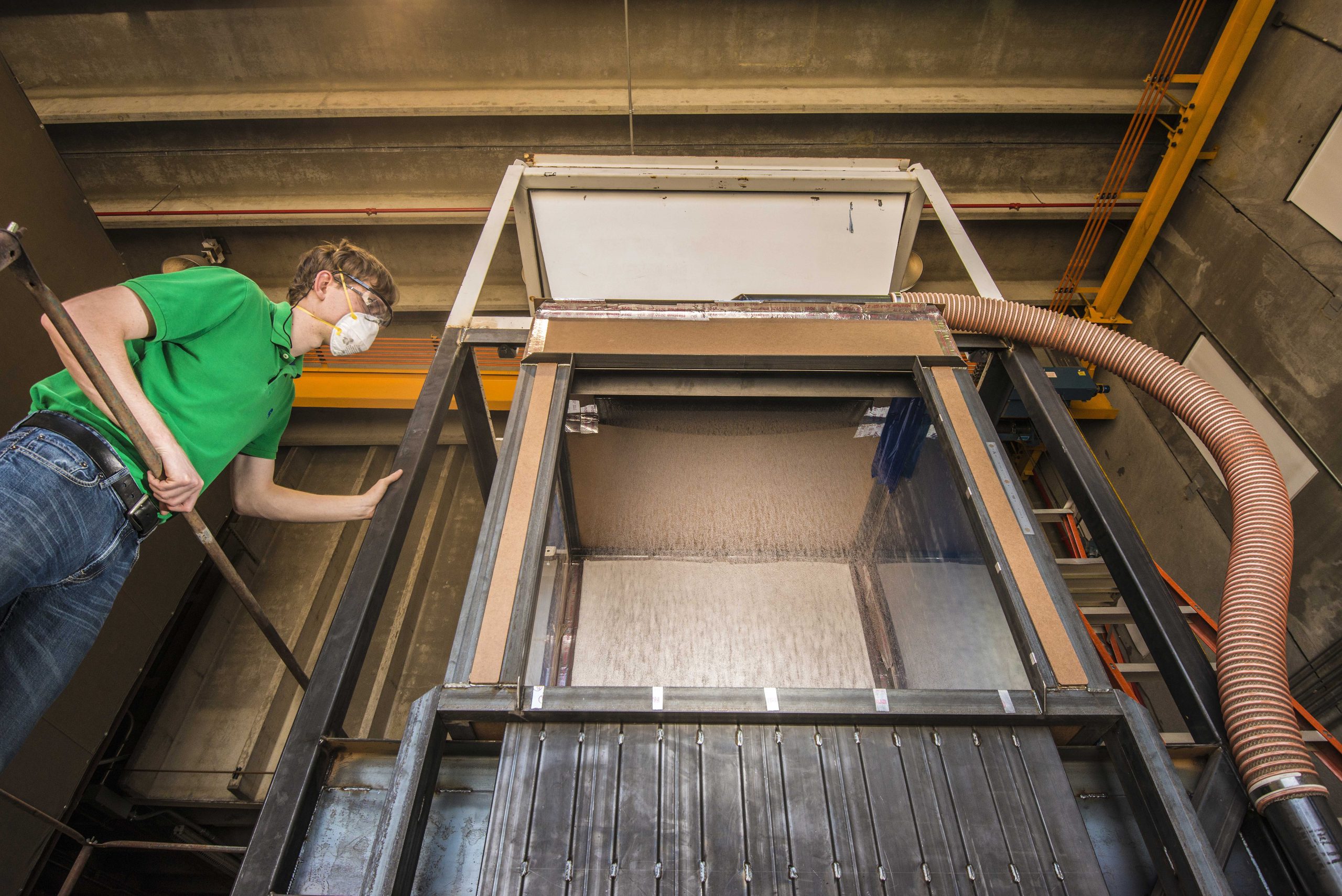 Sandia National Laboratories’ Josh Christian works with the falling particle receiver during a test. Sandia will receive $10.5 million from the Department of Energy to help make concentrating solar power cheaper and more efficient.