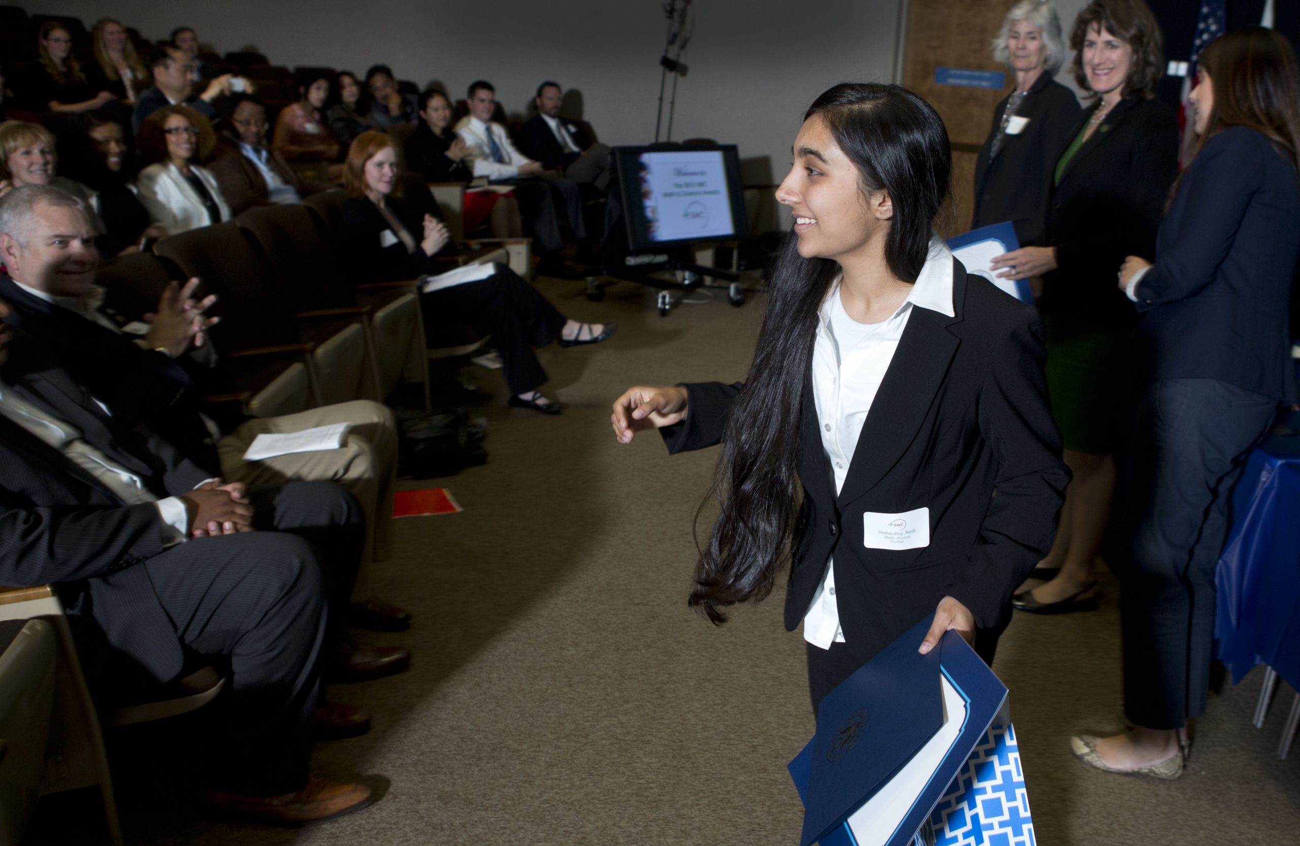 Suhasiny Naik, a student at Foothill High School in Pleasanton collects her award for academic achievement in math at Sandia's 24th annual Math and Science Awards.