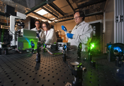 Jesse Aaron, left, Jeri Timlin, and Bryan Carson in their laboratory working with new imaging techniques to view cell-level activity with unprecedented detail.