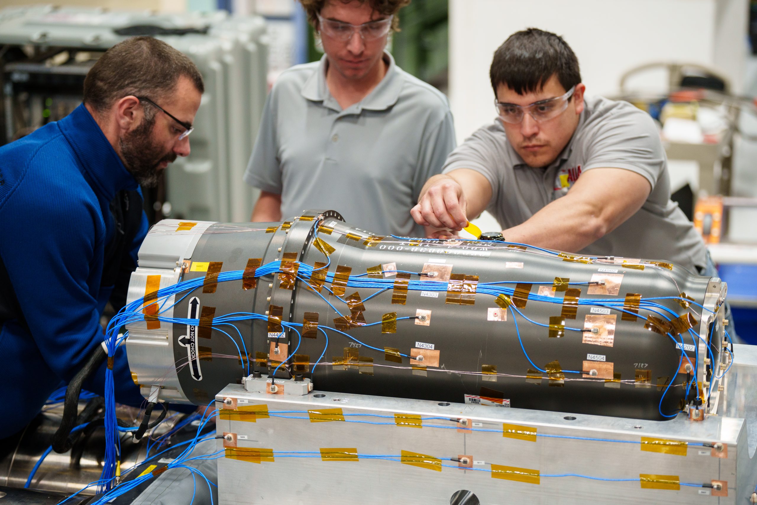 Engineers check the instrumentation on an inert W80-4 prior to testing the warhead on the six degrees of freedom shaker table. Sandia National Laboratories has one of only a few of the shaker table machines in the country.