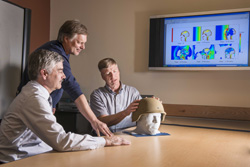 Paul Taylor, right, and John Ludwigsen, center, both researchers with Sandia’s Terminal Ballistics Technology Department, and Corey Ford, a neurologist at the University of New Mexico's Health Sciences Center, discuss their research on traumatic brain injuries. The researchers are comparing supercomputer simulations of the physical effects of blast waves on the brain with Ford's analyses of patients who have suffered such injuries.
