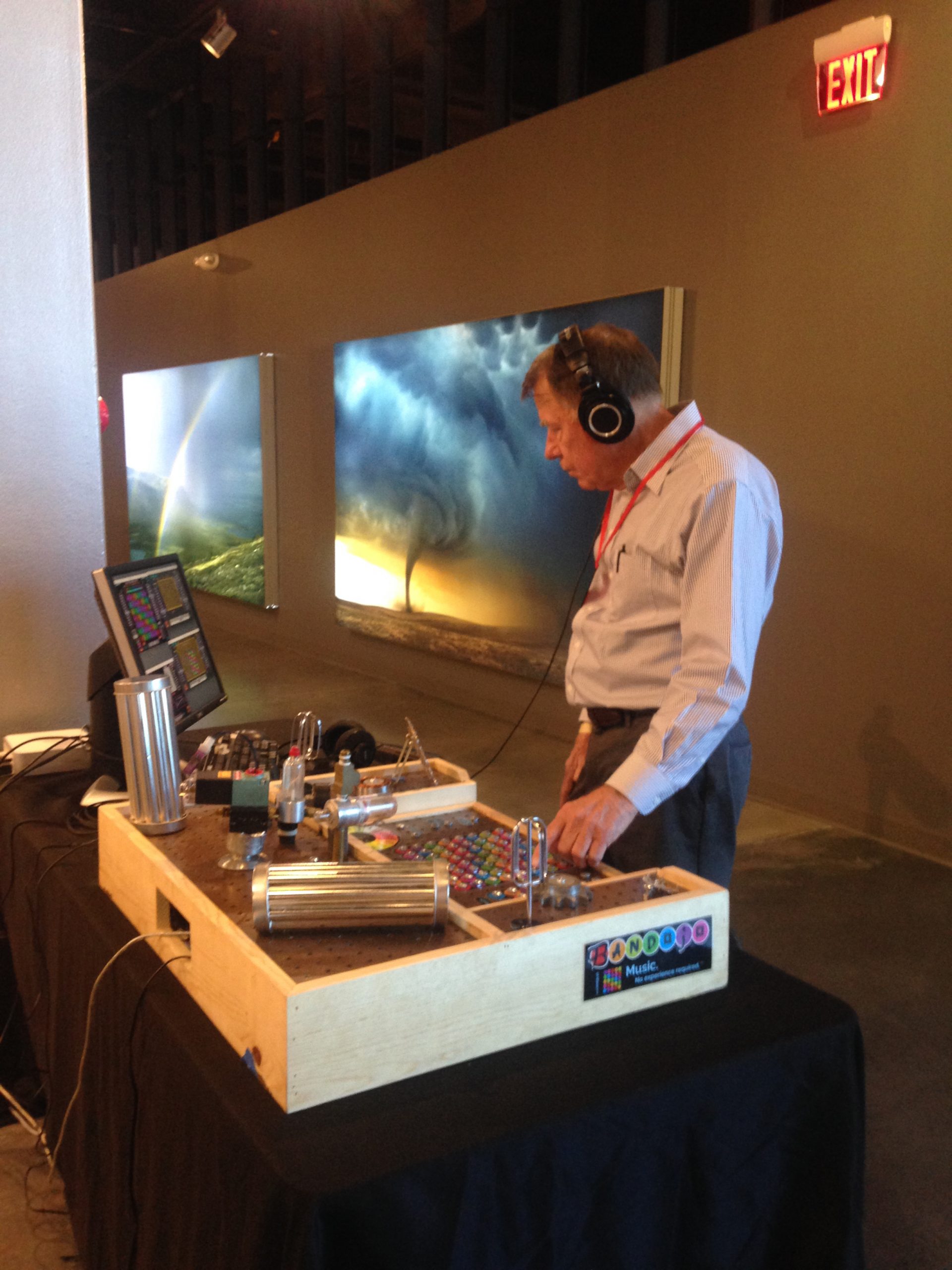 Sandia National Laboratories retiree Mike Murphy checks the sound at a demonstration in Albuquerque of the PanMuse computer-based music system Bandojo. Murphy, an electrical engineer, and two other Sandia retirees helped PanMuse create a physical touch-sensing system for the product.