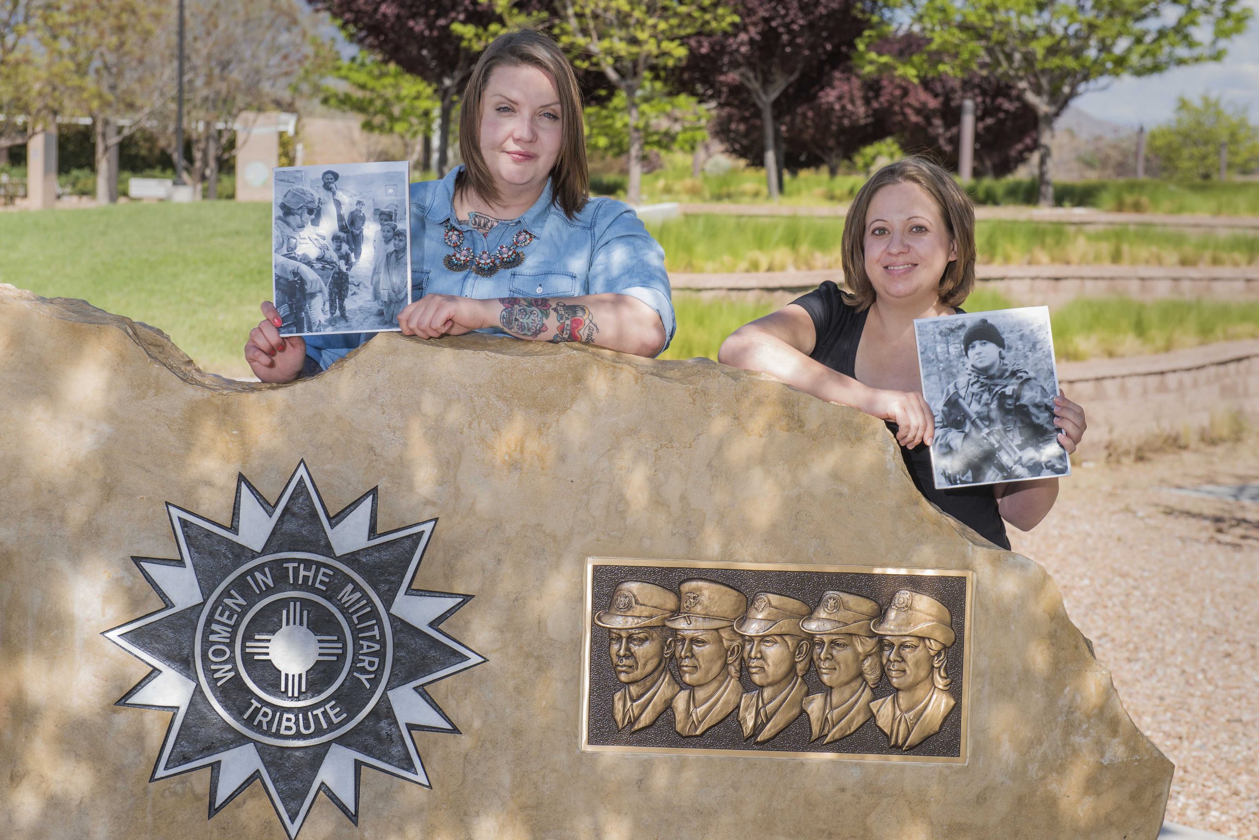 Sandia National Laboratories veterans Lindsey Kibler and Gabrielle Holcomb hold photographs from their service in the U.S. Army at the New Mexico Veterans’ Memorial Park in Albuquerque. Kibler and Holcomb are the first two women to participate in Sandia’s hiring program for combat-injured veterans.