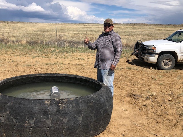 Rancher Dean Gamble gives a thumbs up to new water pumping technology developed by Remote Well Solutions and Sandia that distributes water across his ranch on the Navajo Nation.