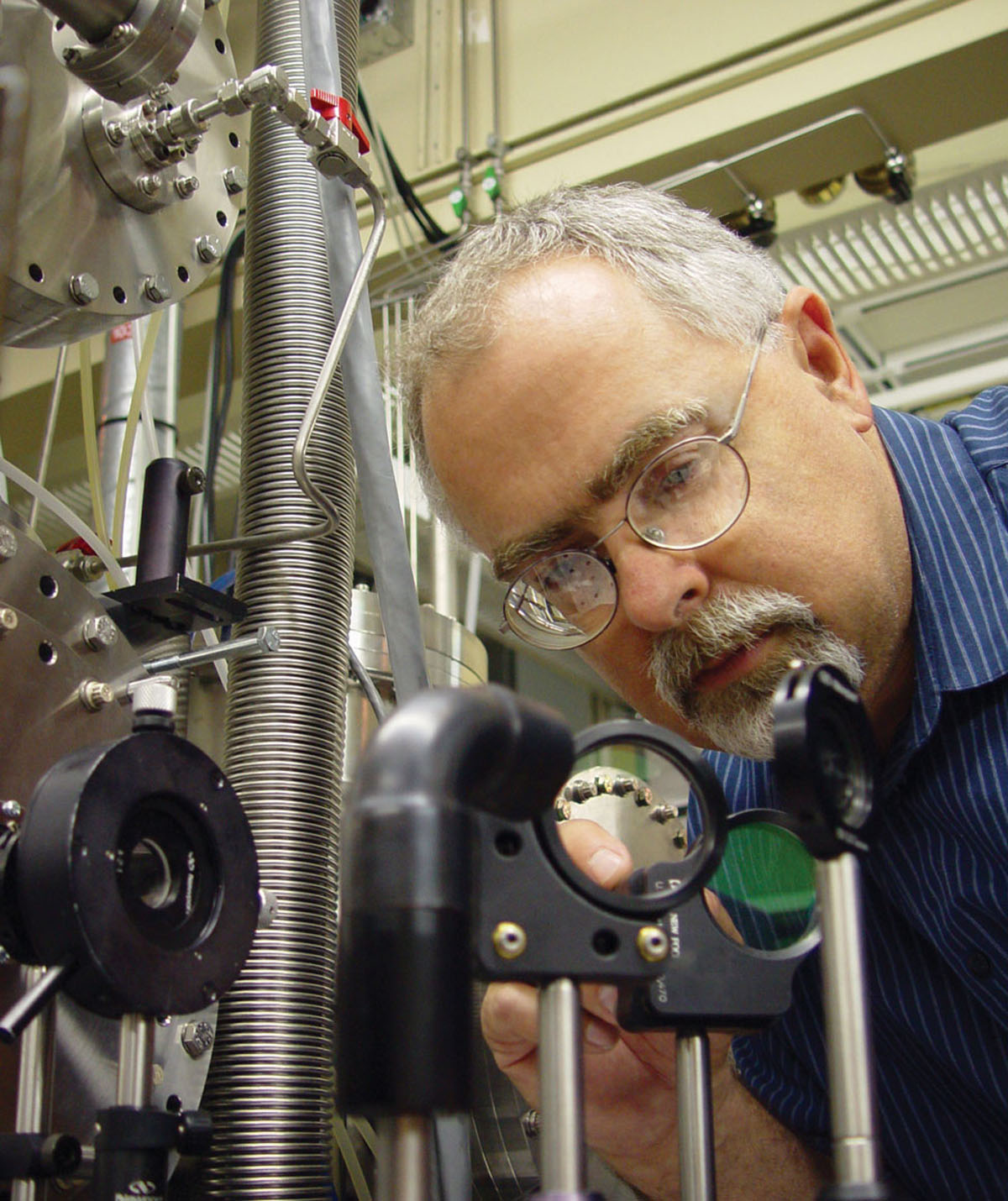 Dave Chandler aligns mirrors used to direct laser beams into an apparatus that generates very cold molecules and measures their velocity.