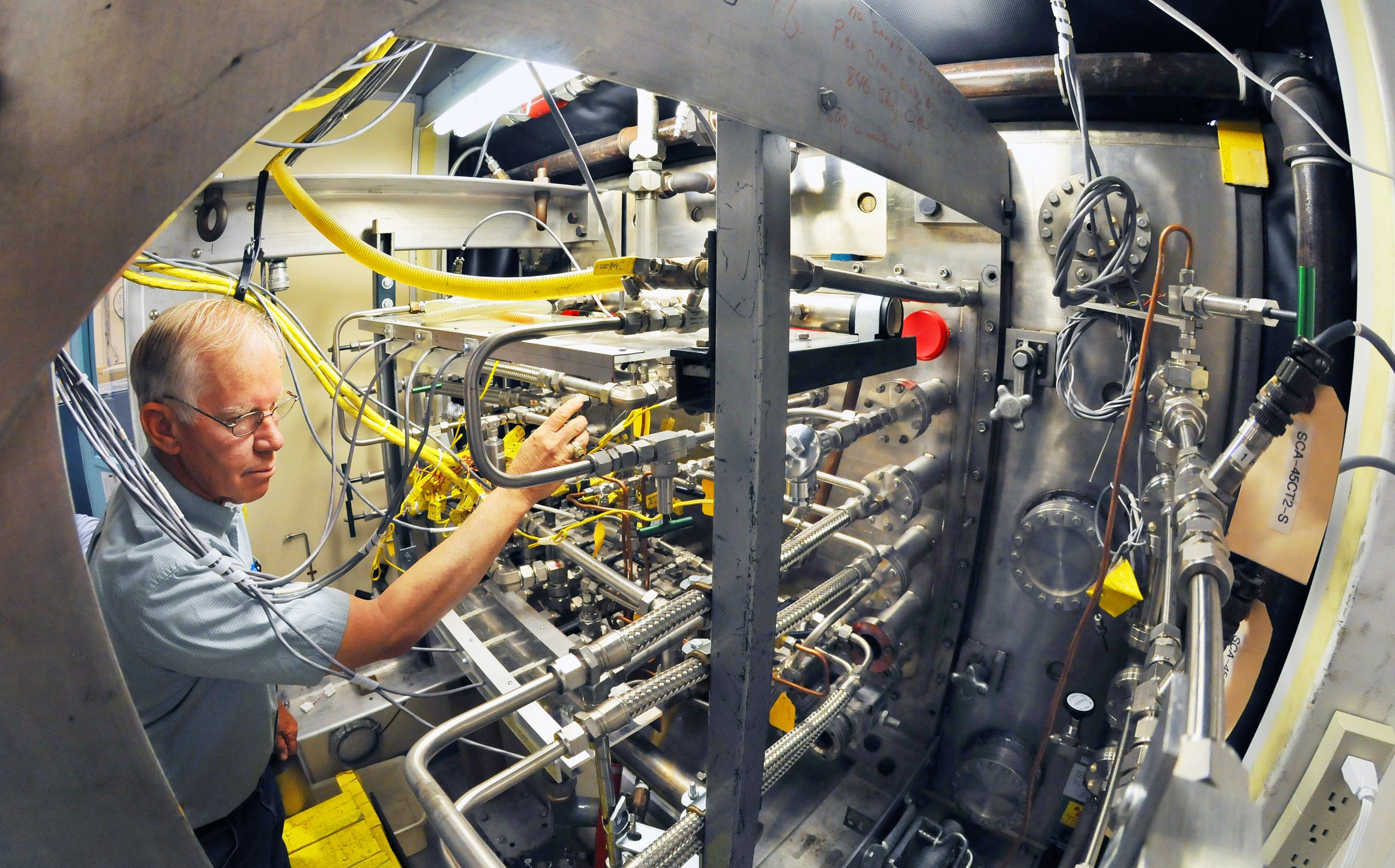 Sandia researcher Jim McDonald checks calorimetry diagnostics for ITER's cooling system. The system supports the front-wall tiles qualified by Sandia as fit for installation in the $14 billion fusion machine under construction in Cadarache, France. (Photo by Randy Montoya) Download 300dpi 8MB JPEG image (Media are welcome to download/publish this image with related news stories.)