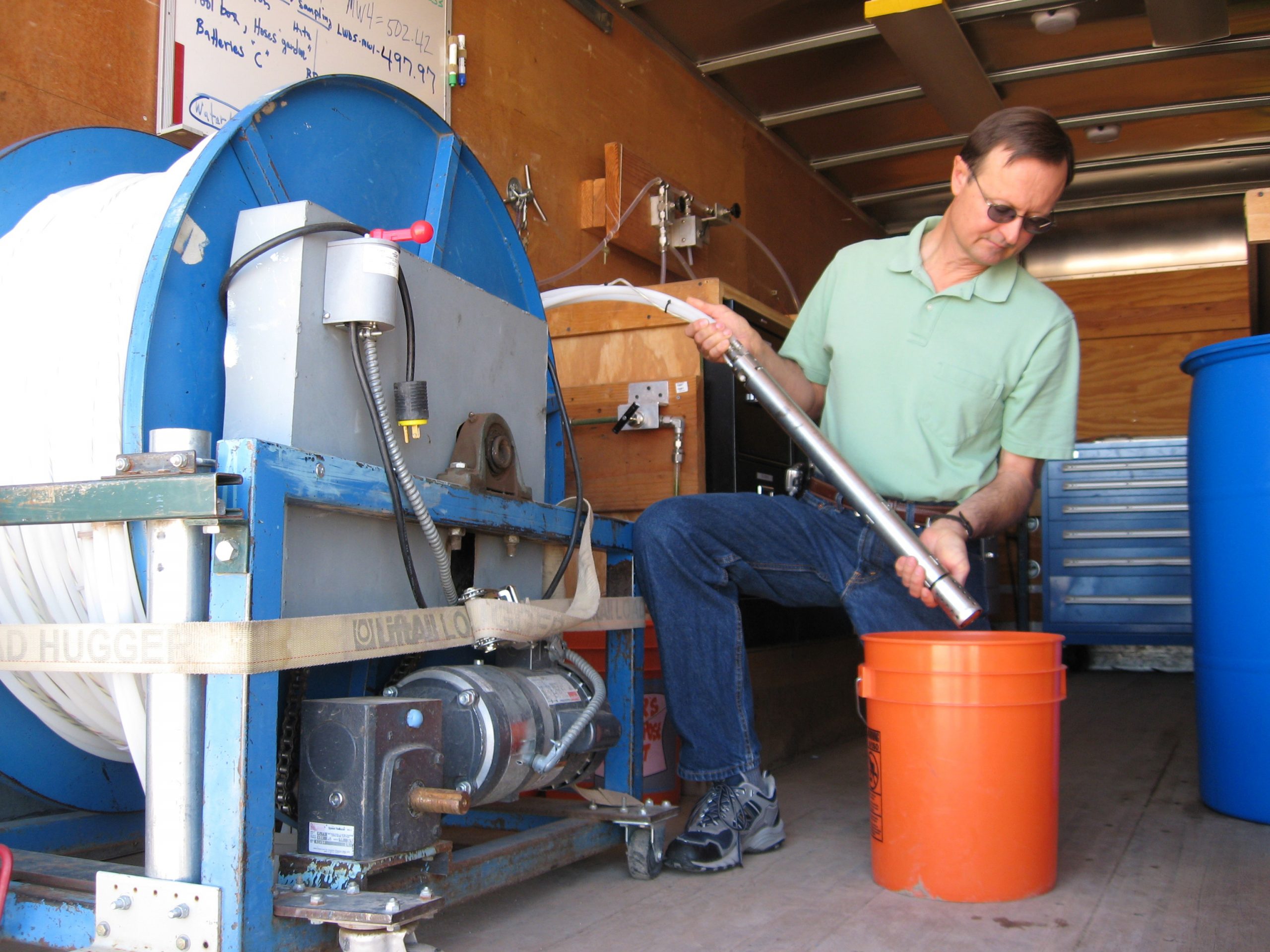 Sandia environmental scientist John Cochran demonstrates the pump used to extract groundwater samples from 150 meter deep monitoring wells at Sandia. (Photo by Michael Padilla).<br />
Download 300dpi 3.25MB JPEG image (Media are welcome to download/publish this image with related news stories.)