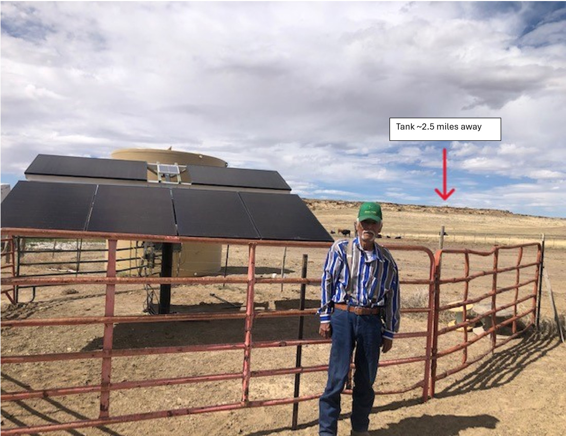 Johny Francis sees the success of the new watering system on his ranch before his passing earlier this year. The arrow indicates the location of the tank that gravity feeds drinkers around the ranch.