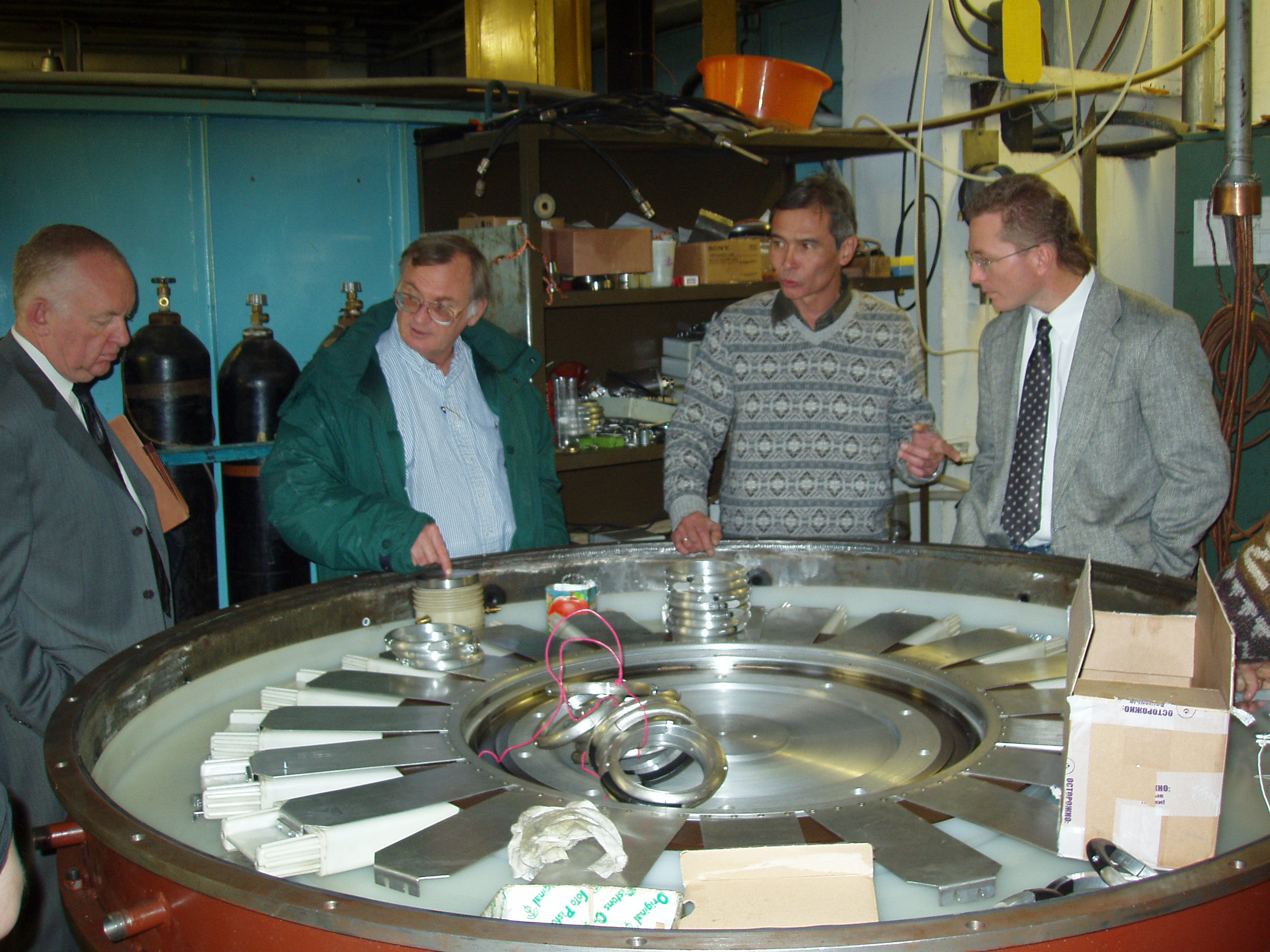 Sandians Dillon McDaniel (second from left) and Steve Glover (right) with Alexandar Kim (HCEI, Tomsk, Russia) examine a 500- kilo-amp LTD for final check-out before shipment from Siberia to Sandia (person on far left is Sandia-hired interpreter; Roman Kahn). The LTD has been in testing at Sandia for the last 2.5 years.