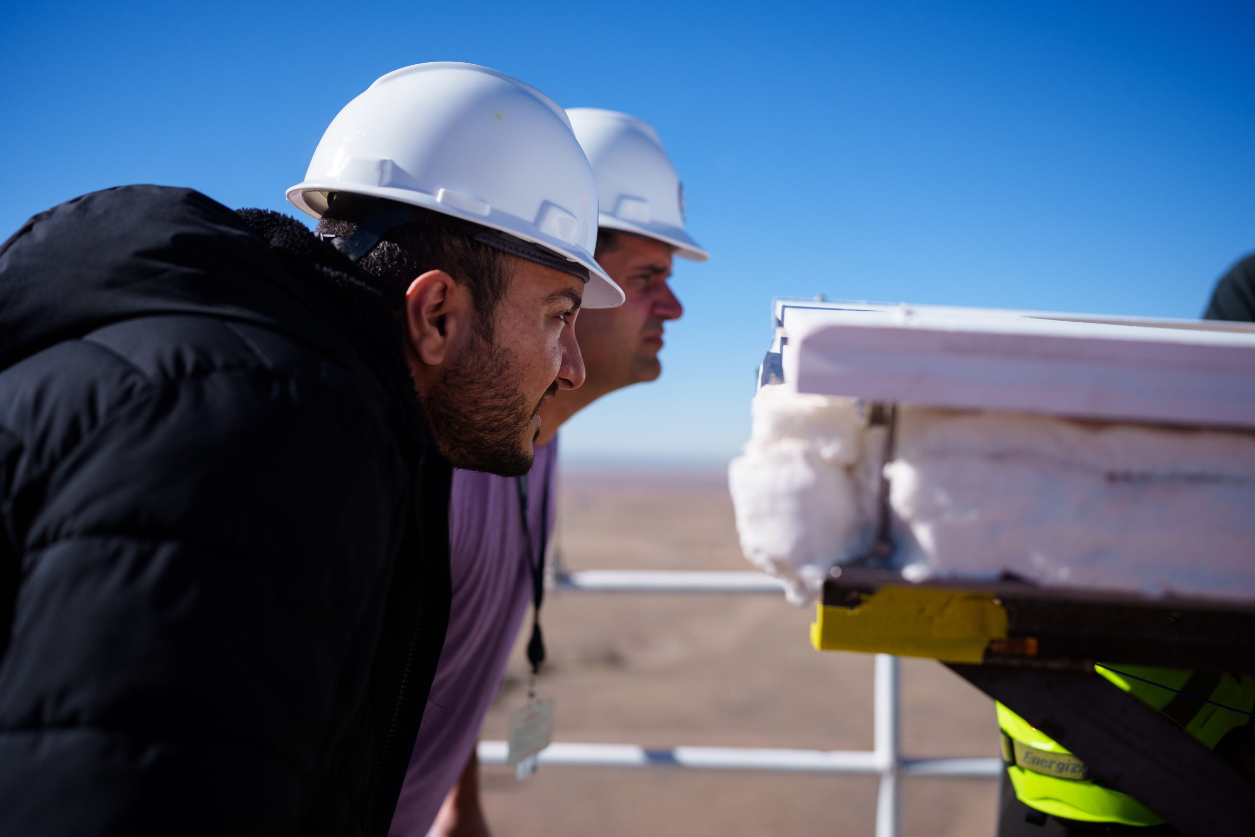 NASA materials engineer Milad Mahzari, front, and NASA project lead Keith Peterson, examine the gas flow around their heat shield during a December 2023 test at Sandia National Laboratories. 