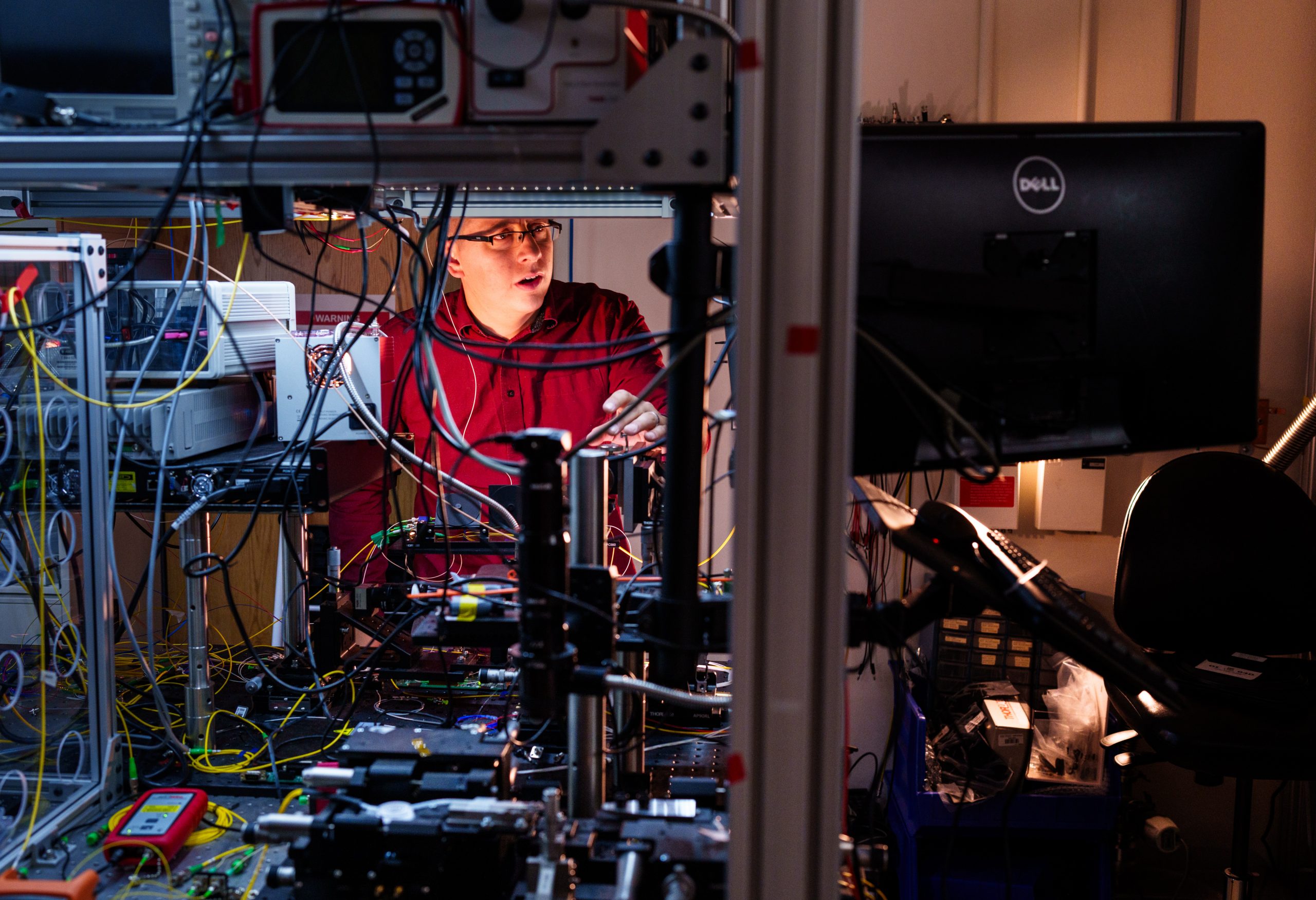 Sandia National Laboratories physicist Nils Otterstrom works to align an integrated photonics chip at the quantum photonics lab. It’s part of ongoing work with Arizona State University to combine the power of integrated photonics and frequency-bin quantum information processing. Recently, Sandia awarded $17 million in Laboratory Directed Research and Development funds to take this work to the next level.