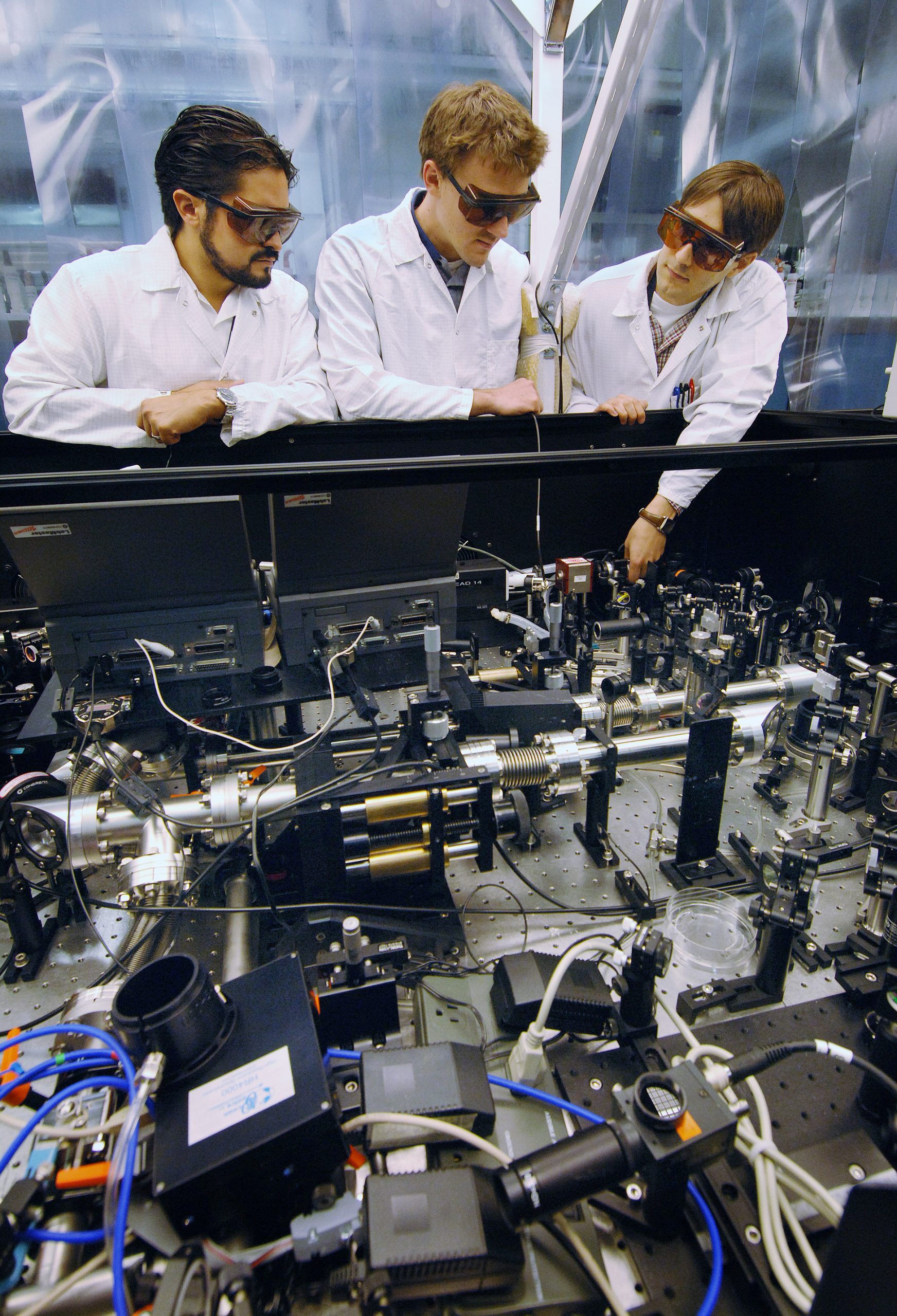 Daniel Headley (left), Marc Ramsey, and Jens Schwarz examine the performance of one their optical clamps as it corrects for laser beam distortion in Sandia’s Z-beamlet laser. (Photo by Randy Montoya)