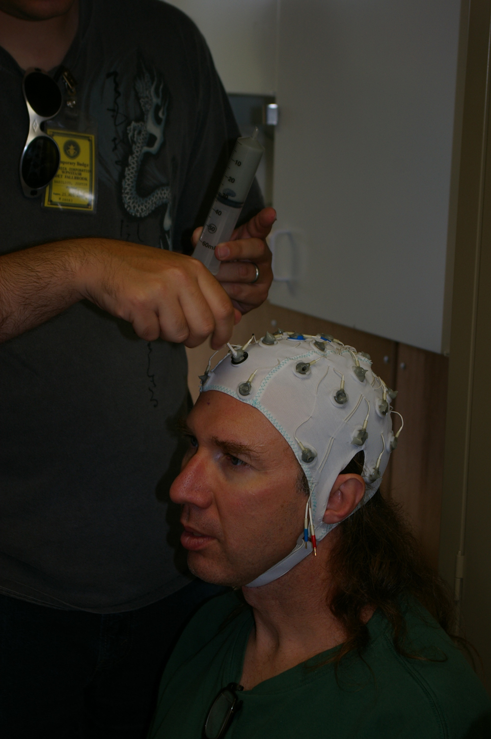 Sandia researcher Chris Forsythe is fitted with a cap connected to electroencephalogram (EEG) (brainwave) electrodes to gauge electrical activity of the brain.