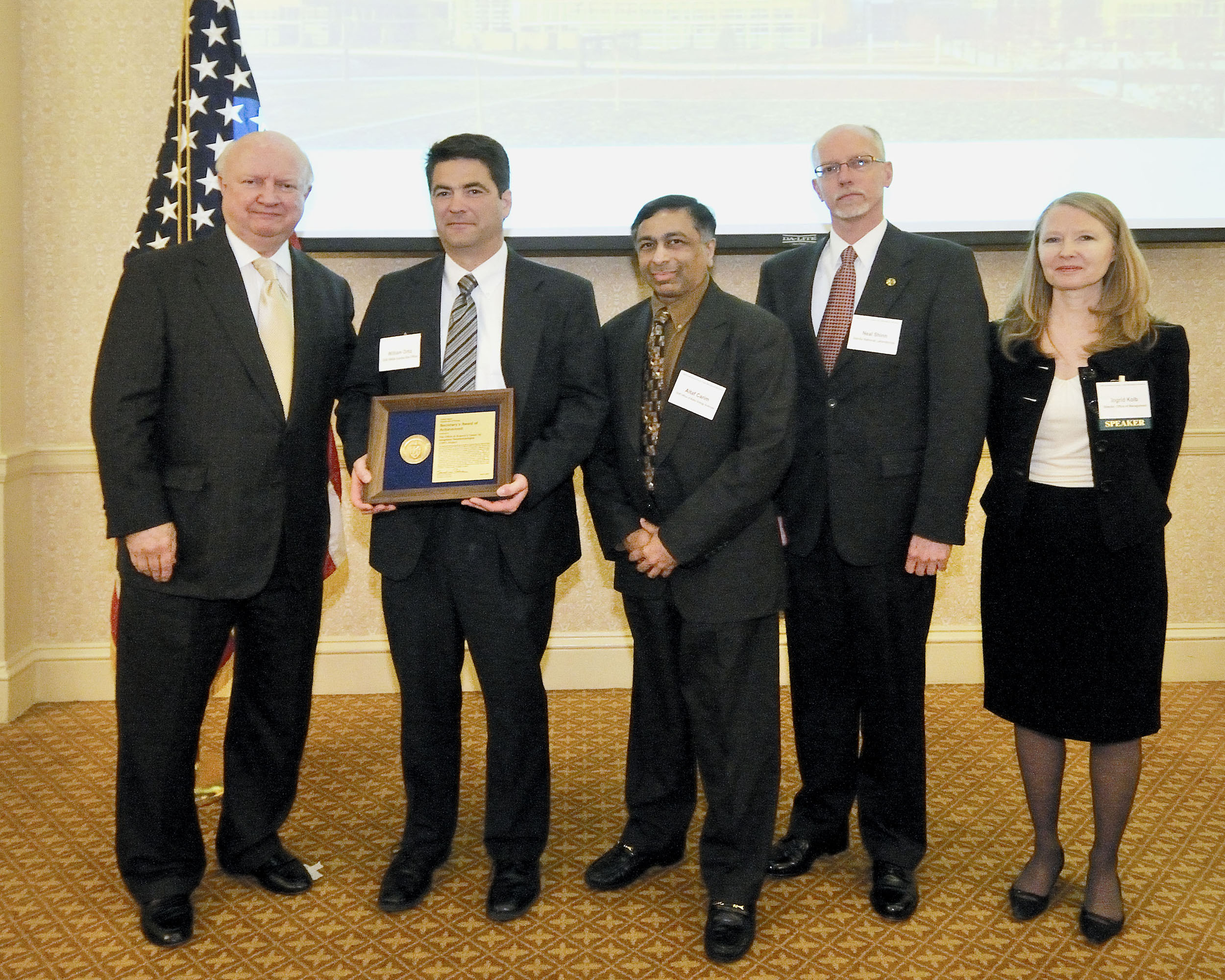 DOE Secretary Samuel Bodman (far left) conveys the Award of Achievement for the timely and efficient construction of the CINT complex to (from left to right) William Ortiz, NNSA Sandia Site Office federal project director; Altaf (Tof) Carim, DOE's Office of Basic Energy Sciences CINT program manager; Neal Shinn, Sandia CINT User Program Manager; and Ingrid Kolb, DOE Office of Management director. Download 300dpi 14MB JPEG image (Media are welcome to download/publish this image with related news stories.)