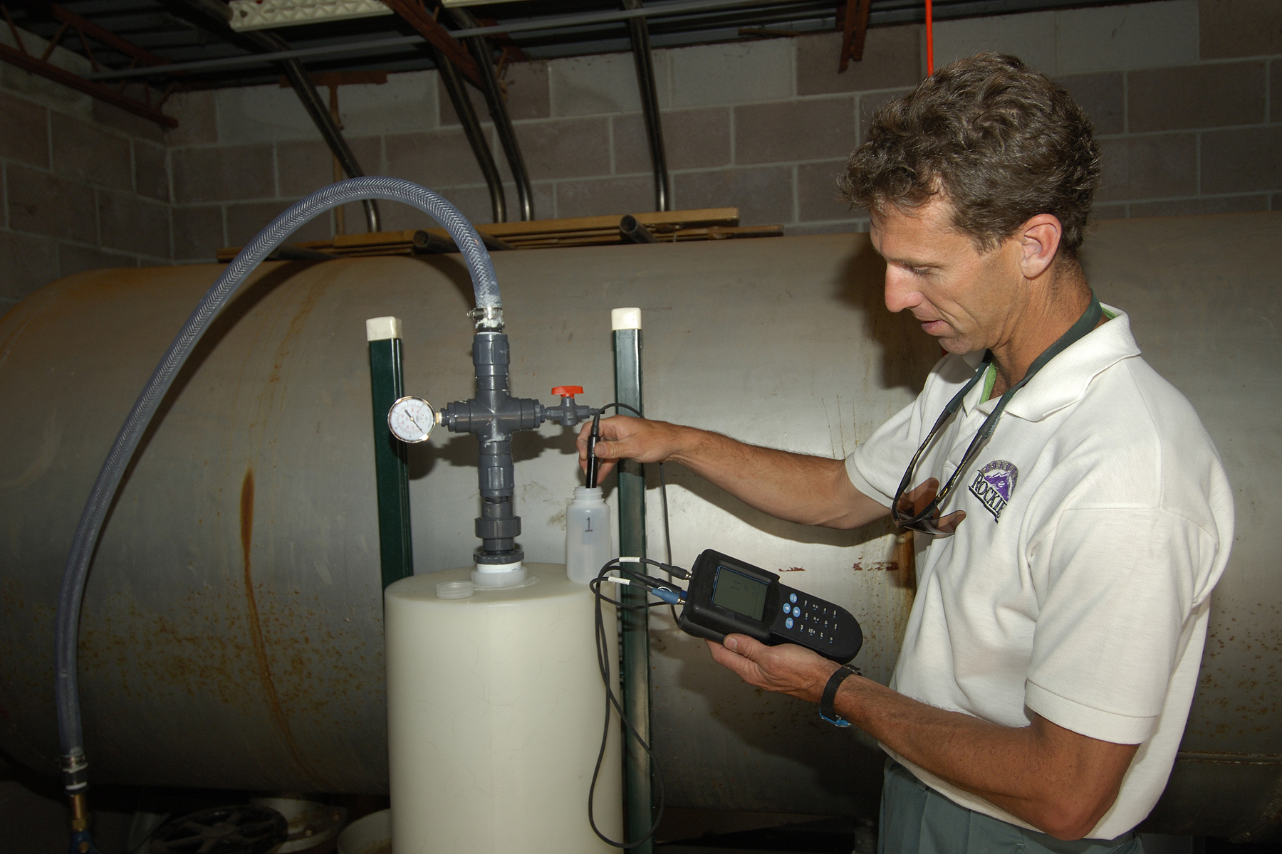 SANDIA RESEARCHER Brian Dwyer checks out arsenic removal equipment at Casa Angelica. The facility’s well provides drinking and bathing water to 16 medically fragile children and young adults who live there. (Photo by Photo by Bill Doty)