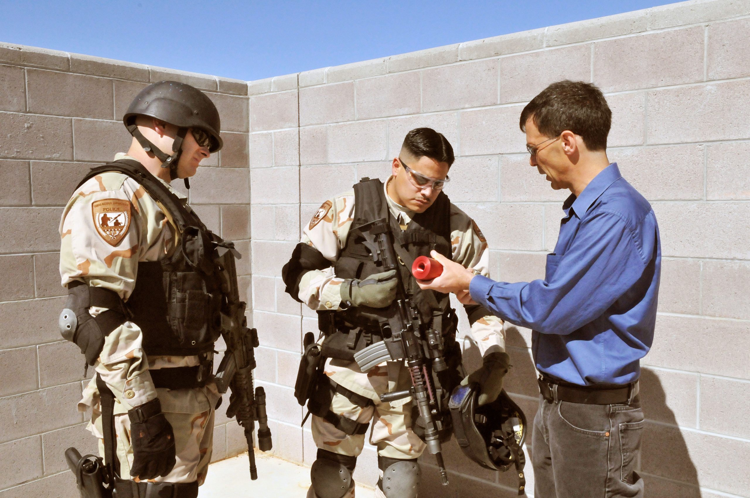 Lt. Chris Dallas and Tristan DeSantis check the flash-bang device.<br />
(Photo by Randy Montoya) Download 300dpi 4MB JPEG image (Media are welcome to download/publish this image with related news stories.)<br />

