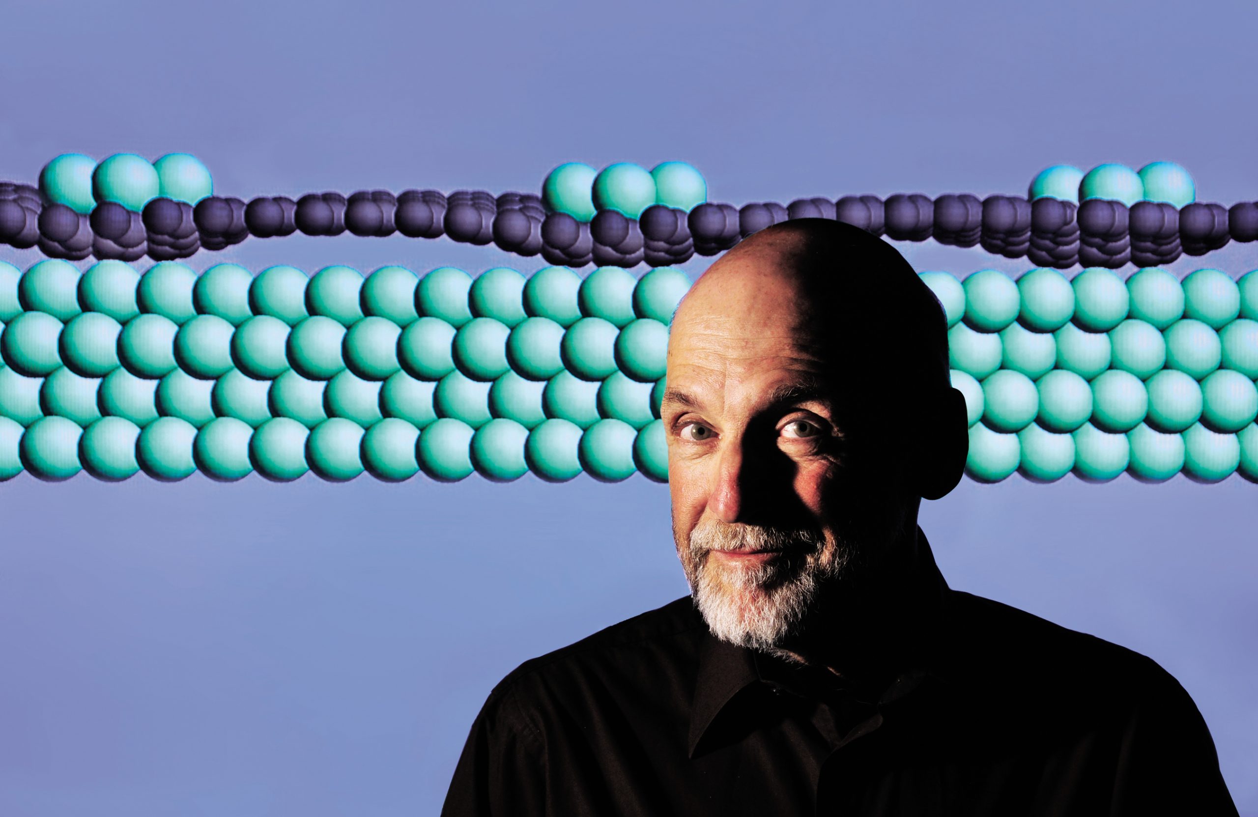 Graphene has proven a difficult material for researchers to tame. Peter Feibelman 's computational simulation suggests an explanation for why iridium atoms (colored green) nest regularly atop a base of graphene (dark-colored atoms) grown over an iridium substrate. Peter’s image of the orderly nanoscopic metallic arrangement may provide insights to other scientists. His paper on the work was published last Thursday in Physical Review B online.<br />
(Photo by Randy Montoya) Download 300dpi 13.5MB JPEG image (Media are welcome to download/publish this image with related news stories.)