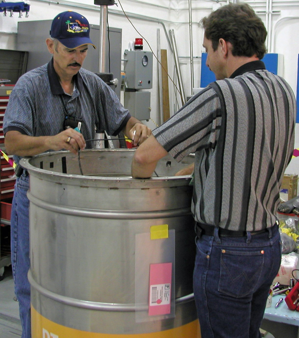 John Garcia and Allan M. Crowder prepare material to be sent to Nevada.