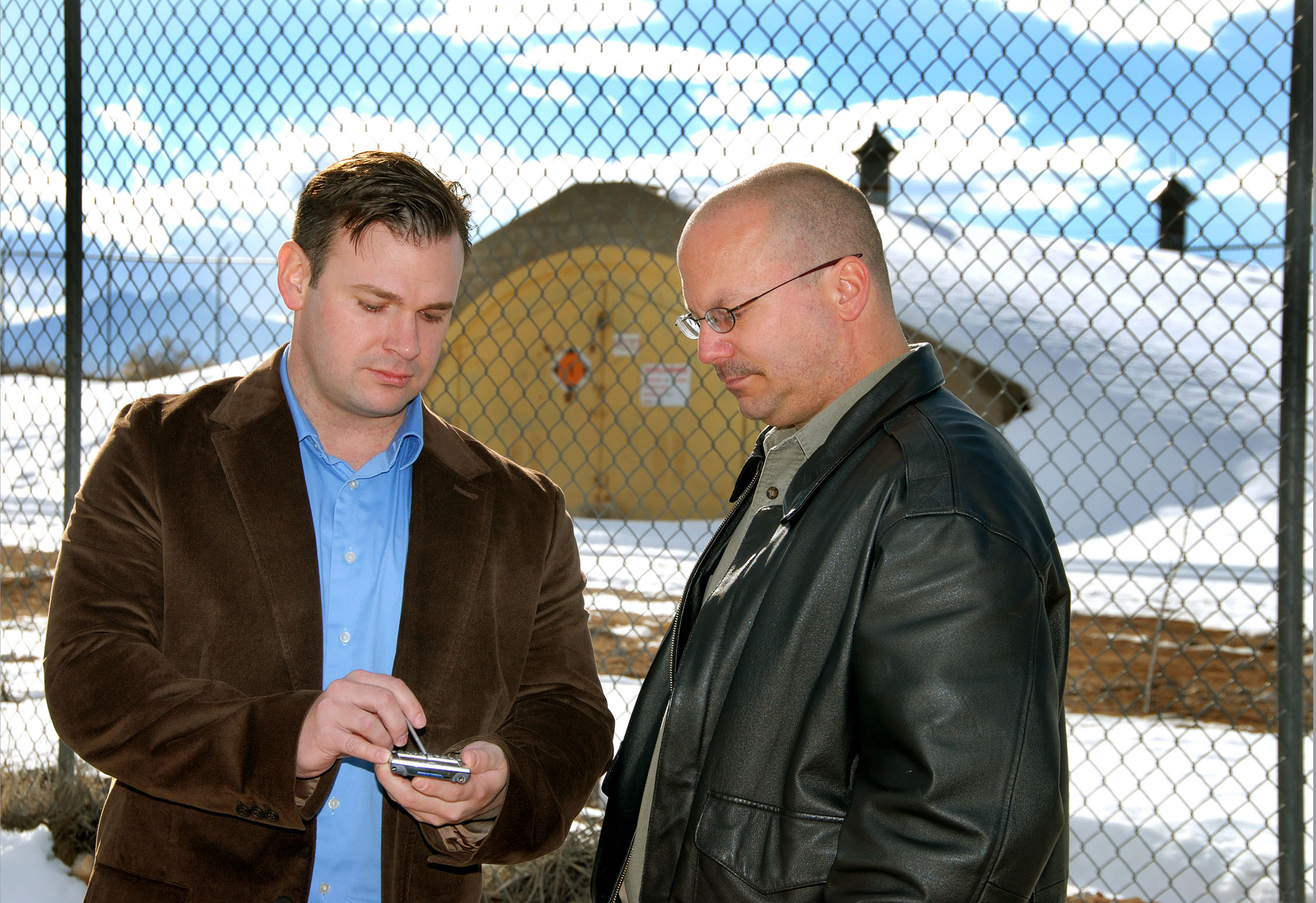 TRACKING ILLICIT TRADE — David York, left, shows Sandia employee John Reynolds a simulation program designed to track illicit trade in fissile and nonfissile radiological material. (Photo by Randy Montoya)