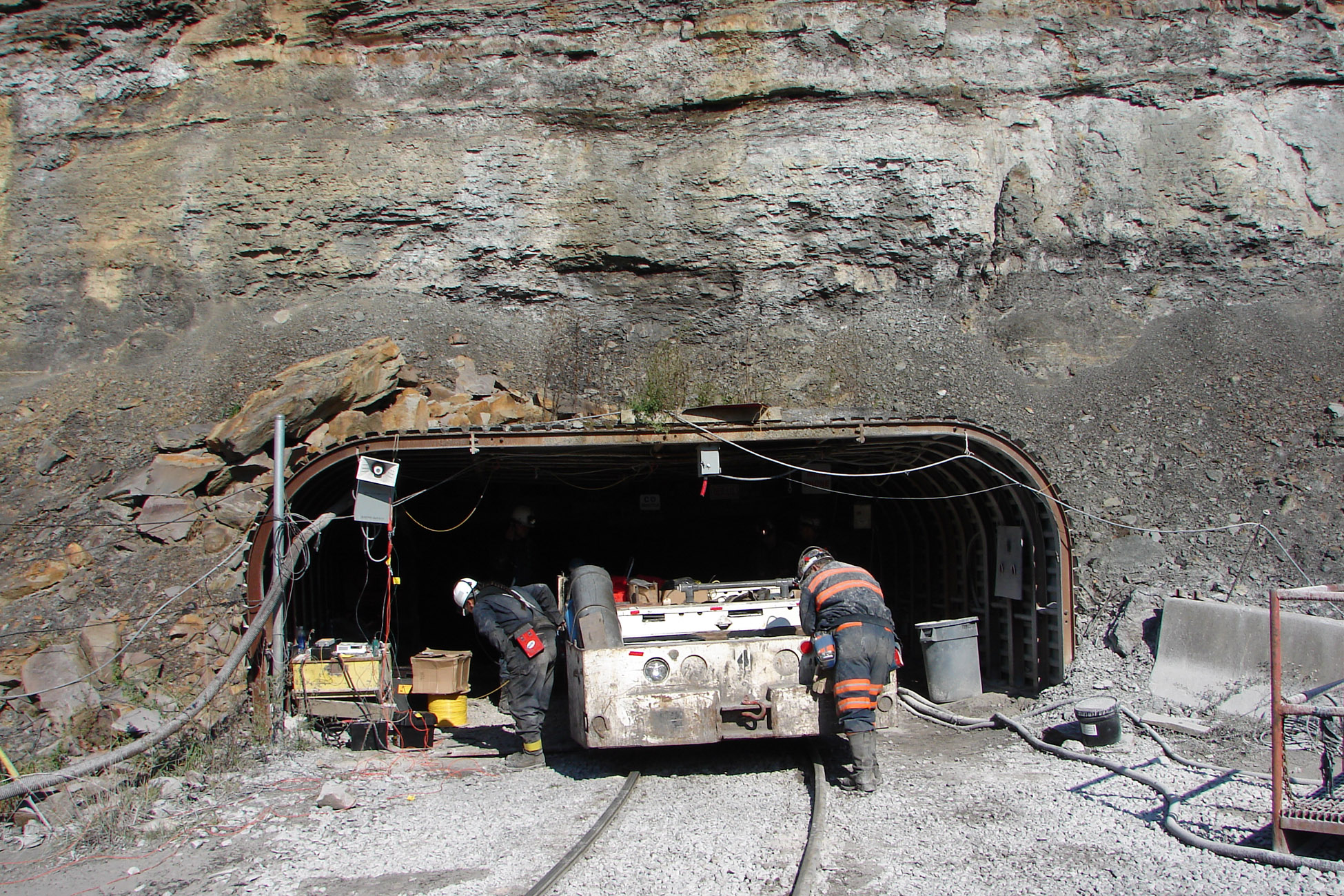 SANDIAN DAWNA CHARLEY, left, and a Sago miner work with a vehicle, called a “mantrip,” before it enters the mine as part of experiments the Labs personnel conducted at the site last November.