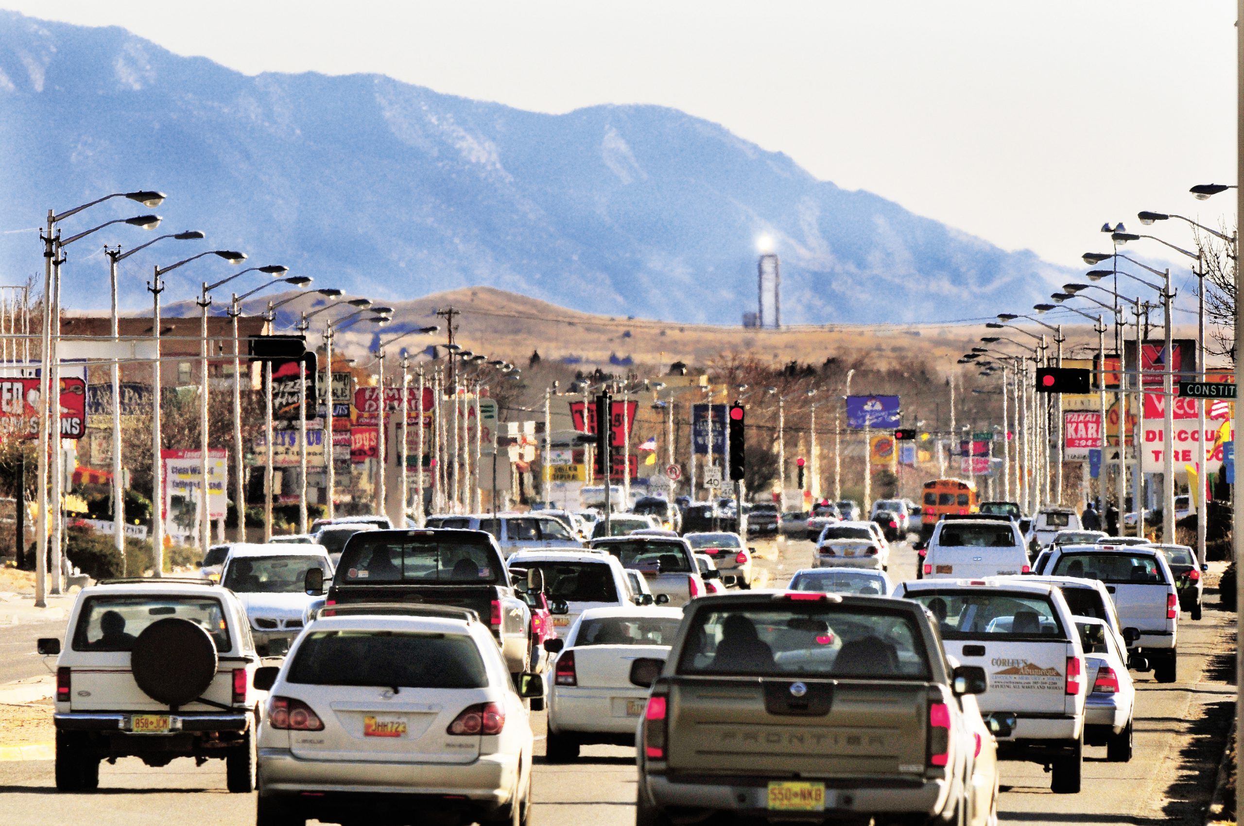 Traffic on Juan Tabo Boulevard in Albuquerque's Northeast heights stacks during a peak time of the day. In the distance, Sandia's solar tower, its mirror reflecting the New Mexico sunlight, suggests an energy future that will see less reliance on fossil fuels and more on alternative sources.<br />
(Photo by Randy Montoya) Download 300dpi 16MB JPEG image (Media are welcome to download/publish this image with related news stories.)