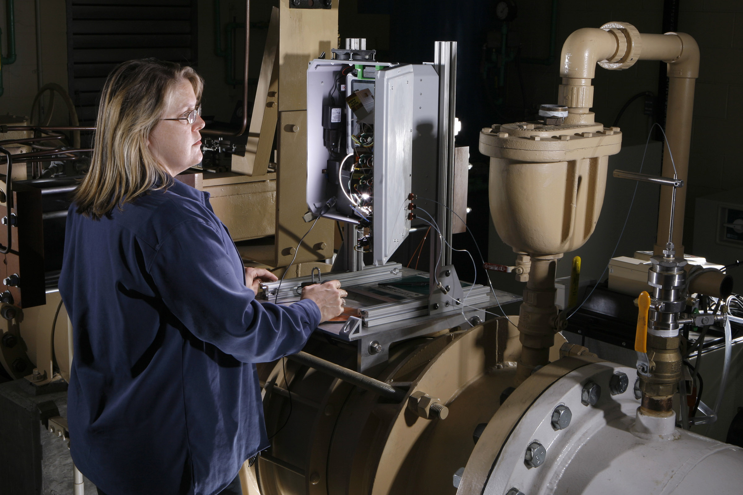 Victoria VanderNoot, an analytical chemist at Sandia, observes operational data displayed by the lab’s unattended water sensor (UWS), shown here at a large water utility in San Francisco’s Bay Area. The UWS has undergone testing at the utility site for more than a year and is now deployed at a municipal water station in Arizona, where operating parameters continued to be fine-tuned.