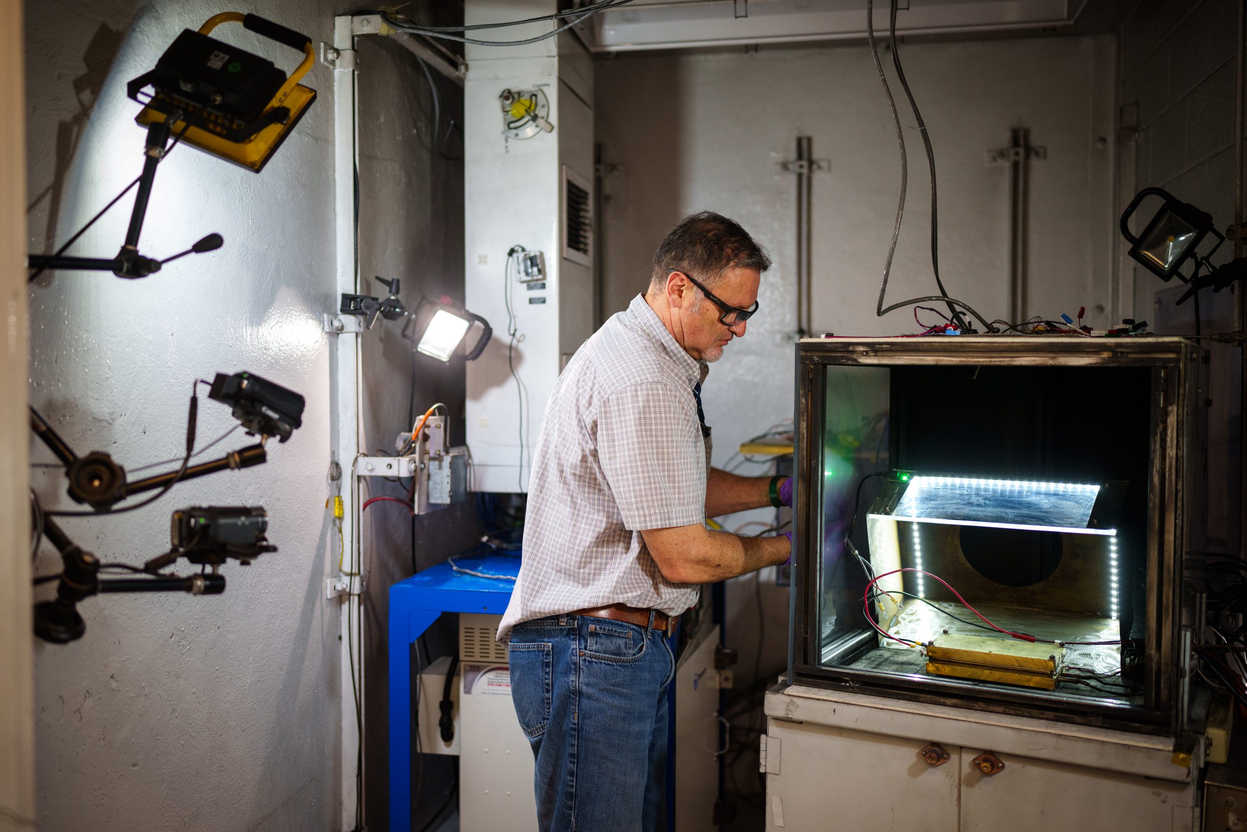 Sandia National Laboratories' Genaro Quintana prepares a battery for testing in a vault at the Battery Abuse Testing Lab. Sandia’s research on detecting battery failures sooner in electric vehicles was published in the Journal of the Electrochemical Society.
