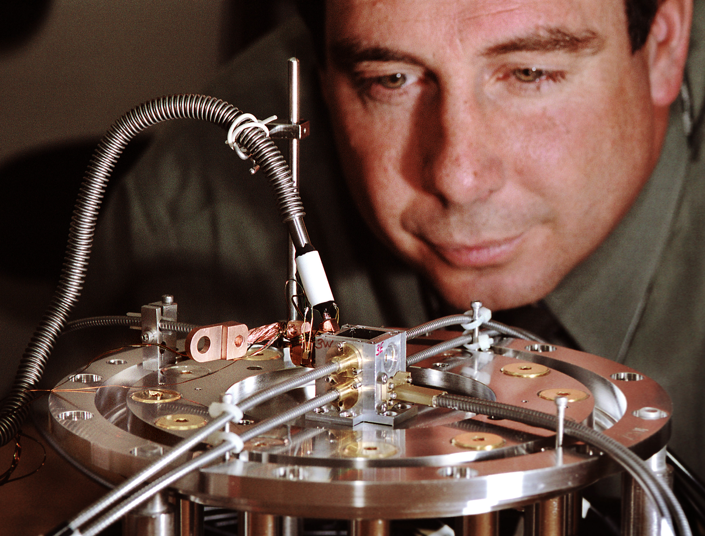 MY BABY — With tender care, Sandia researcher Clint Hall examines one of his group's ICE experiments that created a material response curve for lithium fluoride.