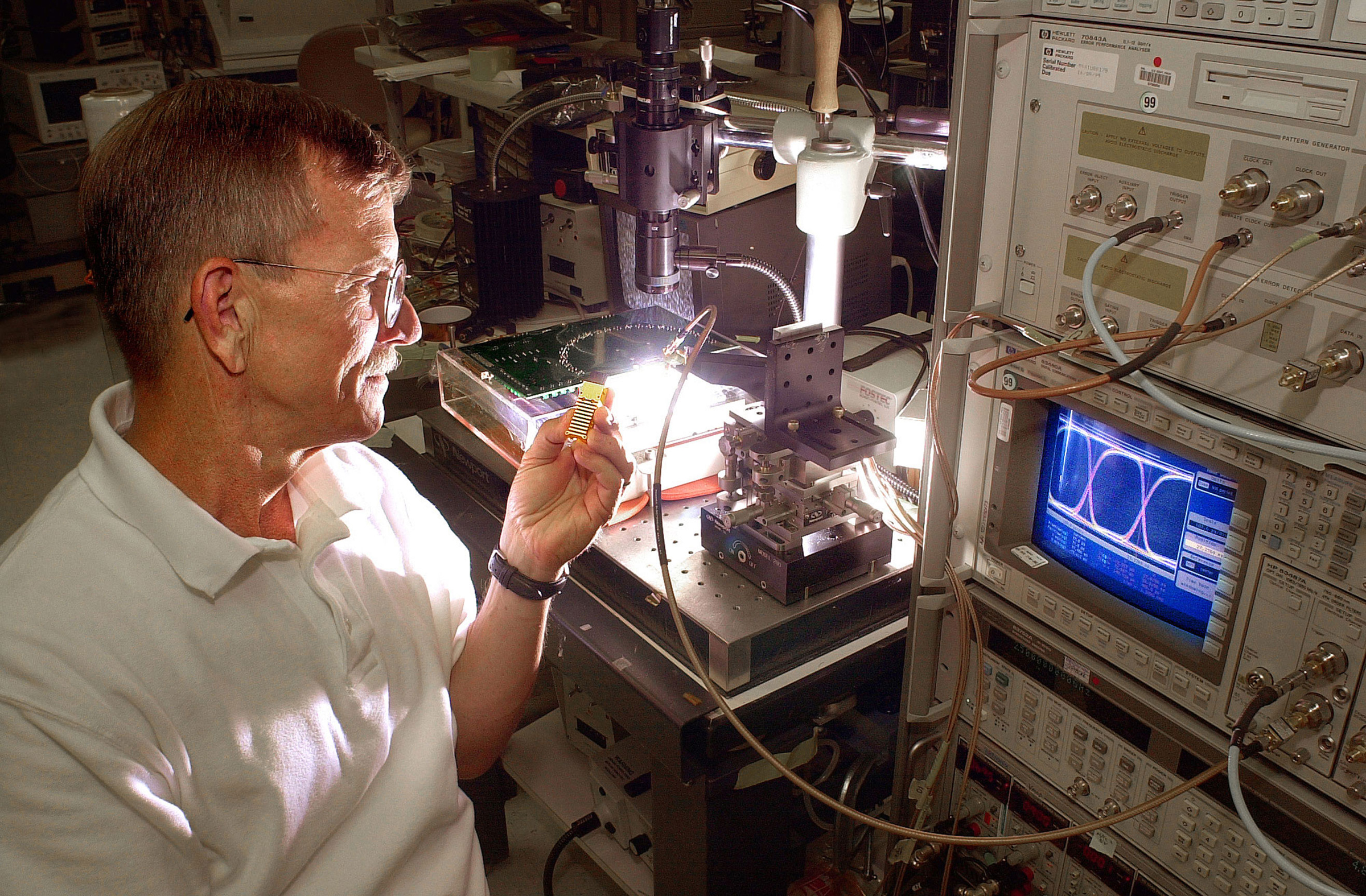 Sandia National Laboratories researcher David Peterson is a member of the EMCORE/Sandia team that won an R&D 100 Award for the MTR8500 Very Short Reach OC-192 Parallel Array Transponder Module that promises to make very short-reach fiber optic communications less expensive. (Photo by Randy Montoya)<br />
Download 300dpi JPEG image, ‘RD100peterson.jpg’, 1MB (Media are welcome to download/publish this image with related news stories.)