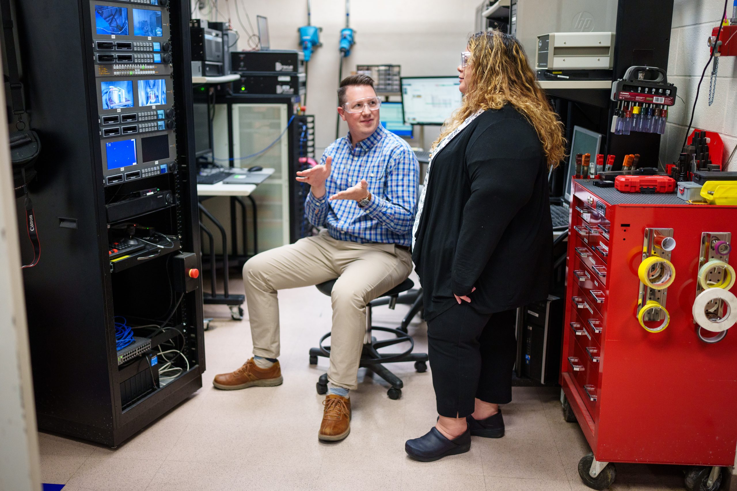Sandia National Laboratories scientists Alex Bates and Loraine Torres-Castro talk about positioning a battery that’s undergoing testing at the Battery Abuse Testing Lab. Their research on electric vehicle batteries aims to detect battery failures more quickly.
