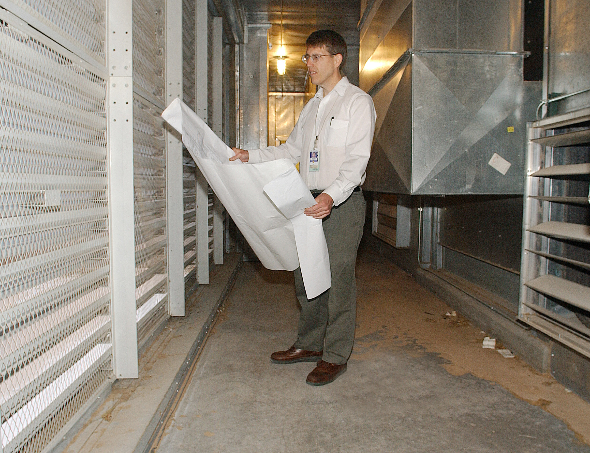 SANDIA RESEARCHER Richard Griffith studies blueprints of a building to better understand airflow. He has led a team that developed modeling and simulation tools for assessing the threat and vulnerability of buildings to biological and chemical assaults. This includes looking at how these agents move and are deposited inside a building. (Photo by Randy Montoya)
