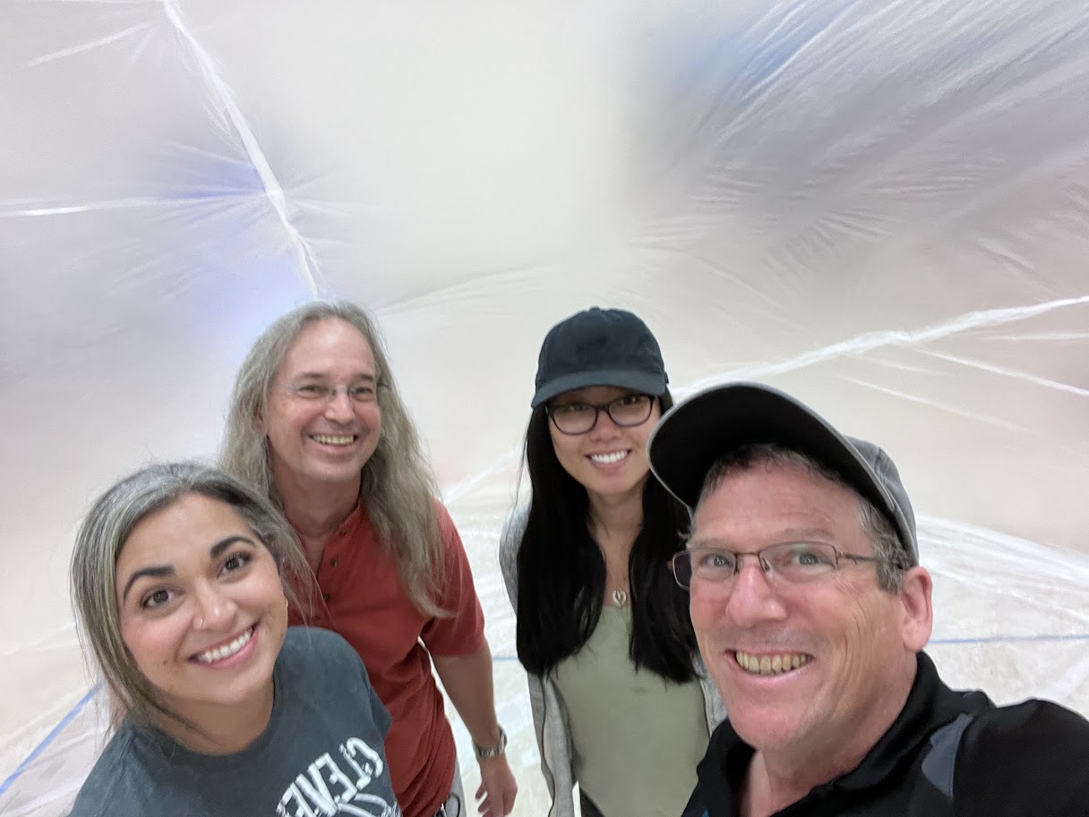 Dan Small, right, takes a selfie with (right to left) fellow Sandia National Laboratories volunteers Jessica Lien and David Novick, and Cleveland Middle School Science chair Vanessa Gonzales at the 2024 balloon launch event.