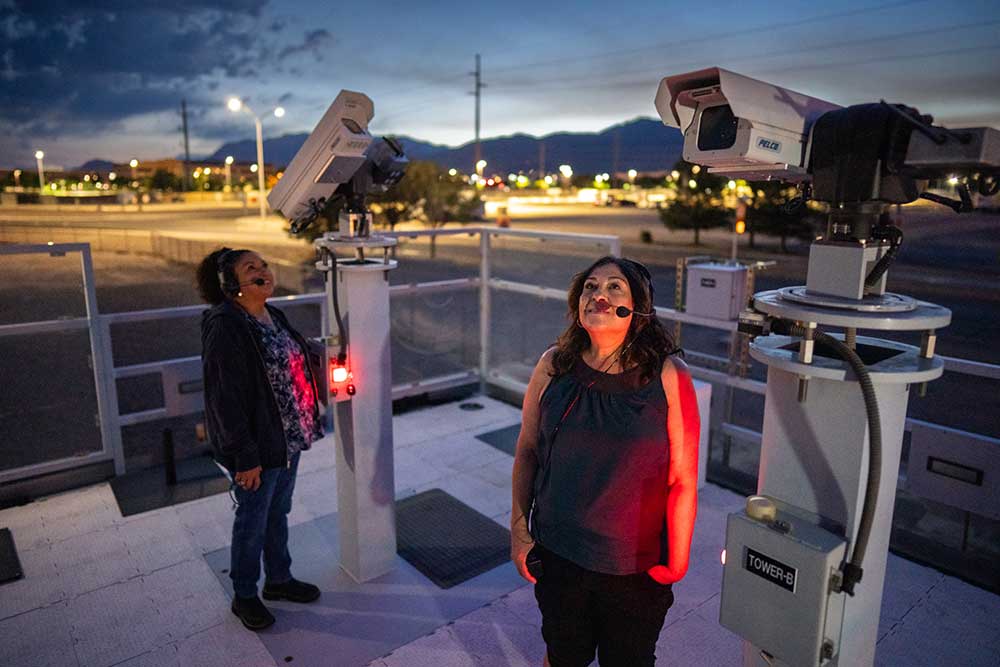 Visual safety observers Debra Yzquierdo, left, and Naomi Baros watch the skies for aircraft atop an observation platform.