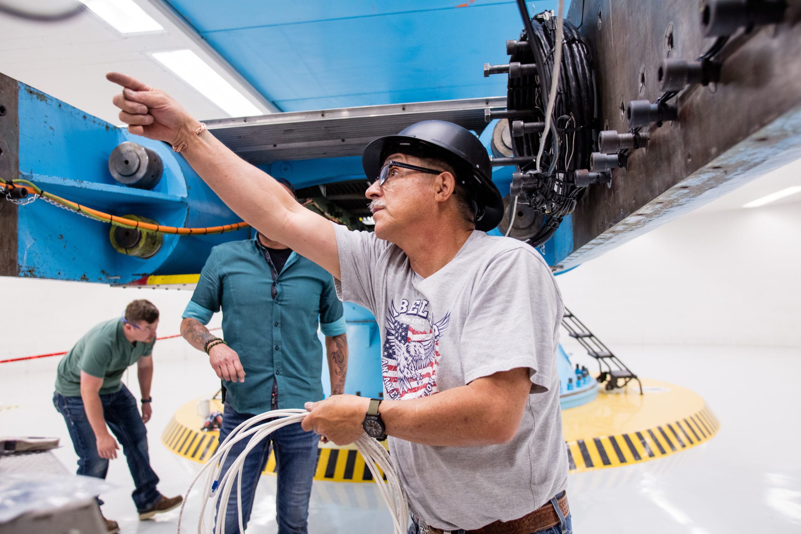 Freddie Martinez figures out electrical connections for testing of the VIPER rover at the Superfuge at Sandia National Laboratories.
