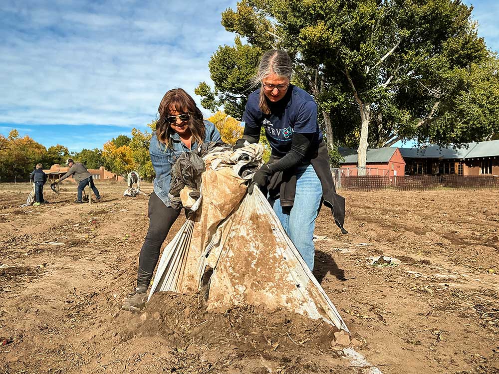 Sandia National Laboratories project manager Josie Gallegos, left, and financial specialist Denise Johnson work at a Seed2Need event in Corrales, New Mexico, on Nov. 1. along with 45 other volunteers.