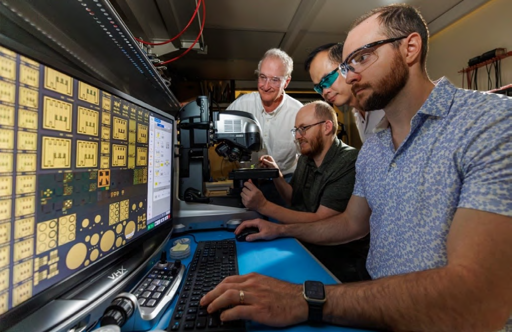 Examination of record-setting hafniagated GaN MOSFETs under an optical microscope at Sandia National Laboratories.