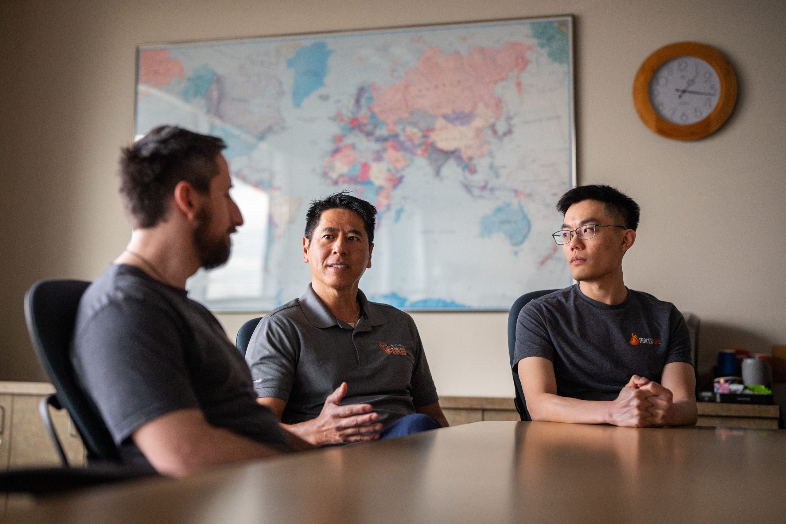 Sandia National Laboratories cybersecurity experts Matthew Trotter, left, Kinsleigh Wong, right, and manager Han Lin discuss logistics of Sandia’s cyber residency program and the Forensic and Incident Response Exercise also known as Tracer FIRE. 