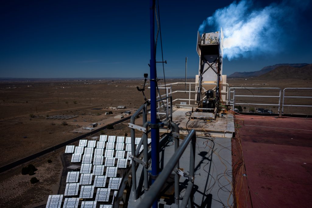 Hundreds of mirror-like heliostats concentrate sunlight on a sample of heat shield material at Sandia National Laboratories’ National Solar Thermal Test Facility. The material, developed by NASA’s Ames Research Center for the Dragonfly mission, was subjected to a pulse of heat that exceeded 4,500 degrees Fahrenheit. (Photo by Craig Fritz) Click on the thumbnail for a high-resolution image.