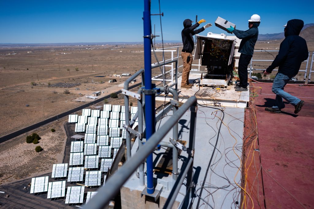 Sandia National Laboratories engineers Aaron Overacker, left, Todd Arterburn, and Lockheed Martin Space engineer Derek Shannon, right, get ready to test heat shield material samples at the National Solar Thermal Test Facility for NASA’s Dragonfly mission to Titan. (Photo by Craig Fritz) Click on the thumbnail for a high-resolution image.