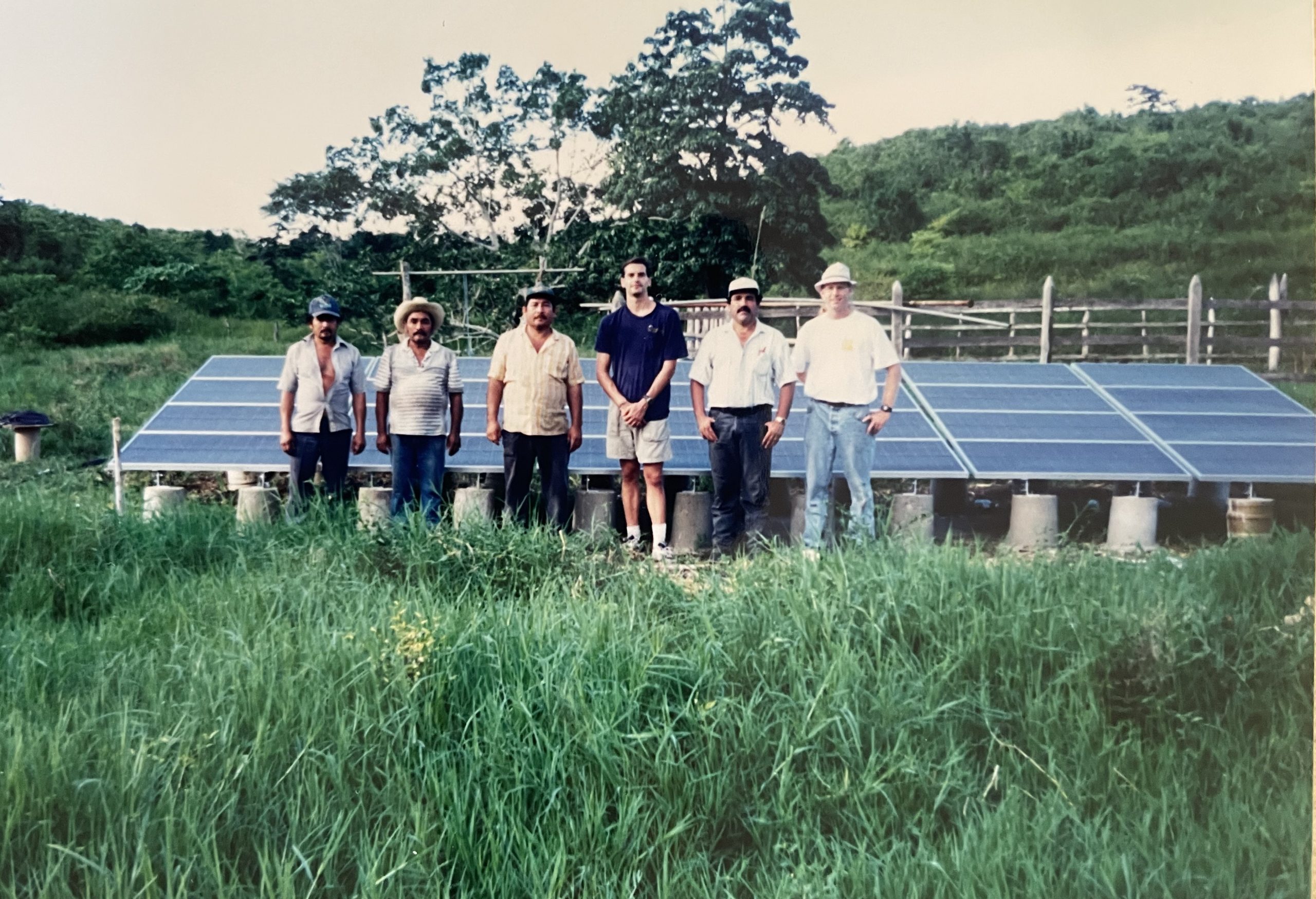 Charles Hanley, right, stands with ranchers in southern New Mexico after helping install a solar water pumping system. 