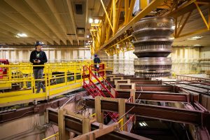 <strong>Sandia National Laboratories technologists Alex Nash, left, and Jacob Werner transport the Saturn Accelerator's Magnetically Insulated Transmission Lines from the center section for cleaning after a shot.</strong> (Photo by Craig Fritz) Click on the thumbnail for a high-resolution image.