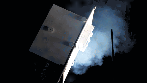 A close look at the heat shield sample, mounted inside the white container. It was exposed to extreme heat through a beam of concentrated sunlight at Sandia National Laboratories’ National Solar Thermal Test Facility.