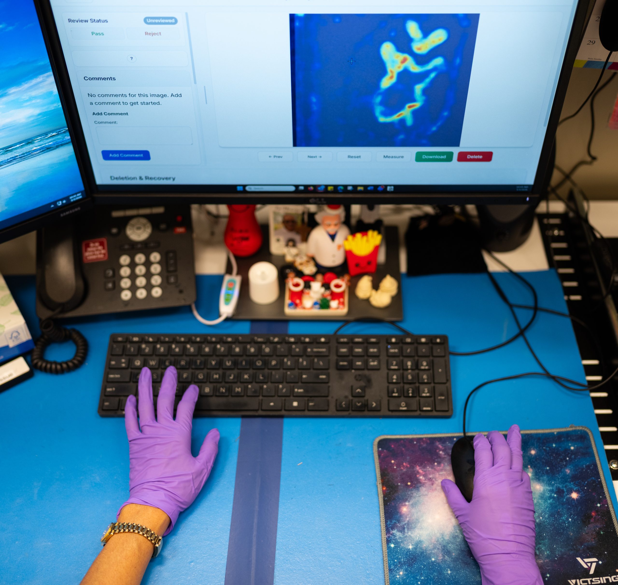 A technician at Sandia National Laboratories reviews a scanned image of a ceramic billet from her desktop. Sandia is transitioning from using a manual inspection to one that uses artificial intelligence to flag defects. Technicians will still review the results for quality control.