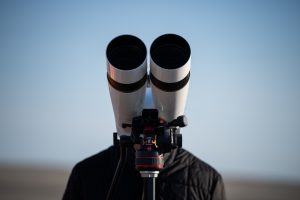 <strong>National Nuclear Security Administration Genesis Mission lead Charles Ball observes the drop test through binoculars.</strong> (Photo by Craig Fritz) Click on the thumbnail for a high-resolution image.