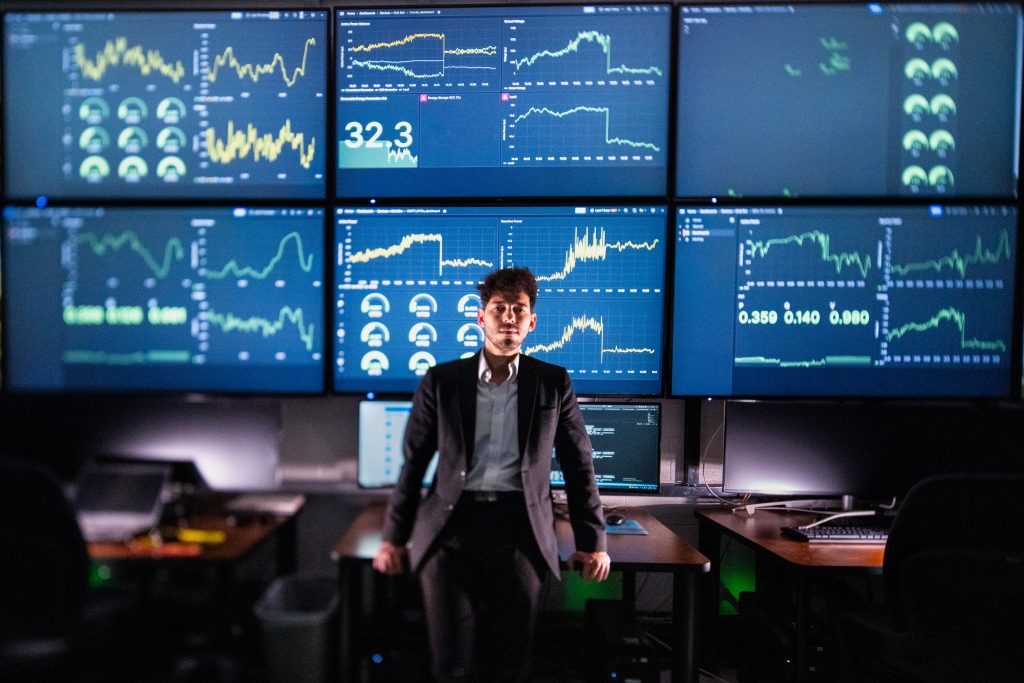 <strong>In Sandia National Laboratories' Distributed Energy Technologies Laboratory, engineer Rachid Darbali-Zamora reviews the DERMS control dashboard used to coordinate grid-connected devices such as inverters, batteries and solar resources. The AI-enabled controls are being tested to improve voltage regulation and power quality for sensitive loads.</strong> (Photo by Craig Fritz)